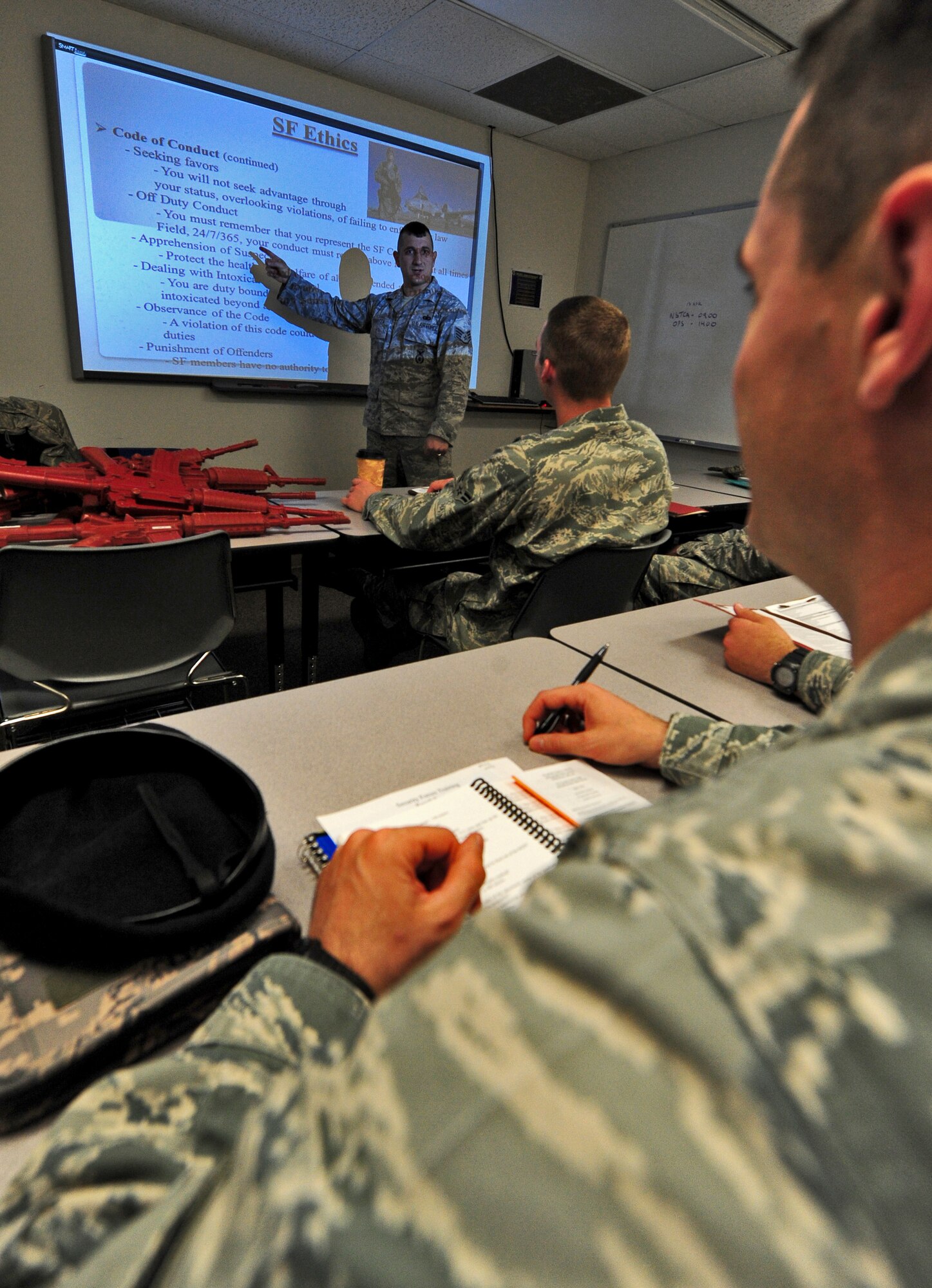 Staff Sgt. Michael Krivitza, 509th Security Forces Squadron Phase I trainer, briefs Airmen new to the squadron about security forces ethics at Whiteman Air Force Base, Mo., April 16, 2013. Kravitza provides training to more than 500 security forces members on a wide range of career-related topics . (U.S. Air Force photo by Staff Sgt. Nick Wilson/Released)