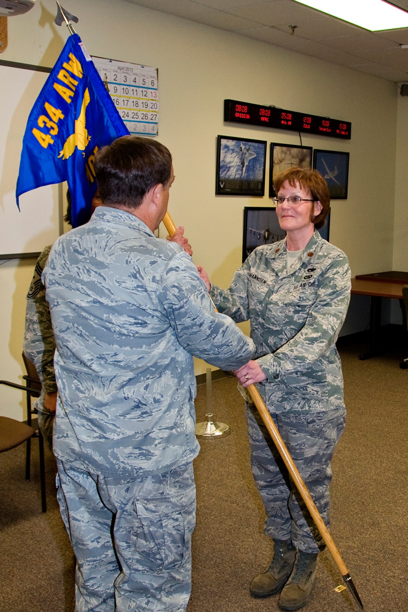 GRISSOM AIR RESERVE BASE, Ind. -- Maj. Amy Johannsen receives the 434th Maintenance Operations Flight guidon from Col. Paul Weimer as she assumes command of the unit here April 13. Weimer is the 434th Maintenance Group commander and presided over the ceremony. (U.S. Air Force photo/Staff Sgt. Carl Berry)
