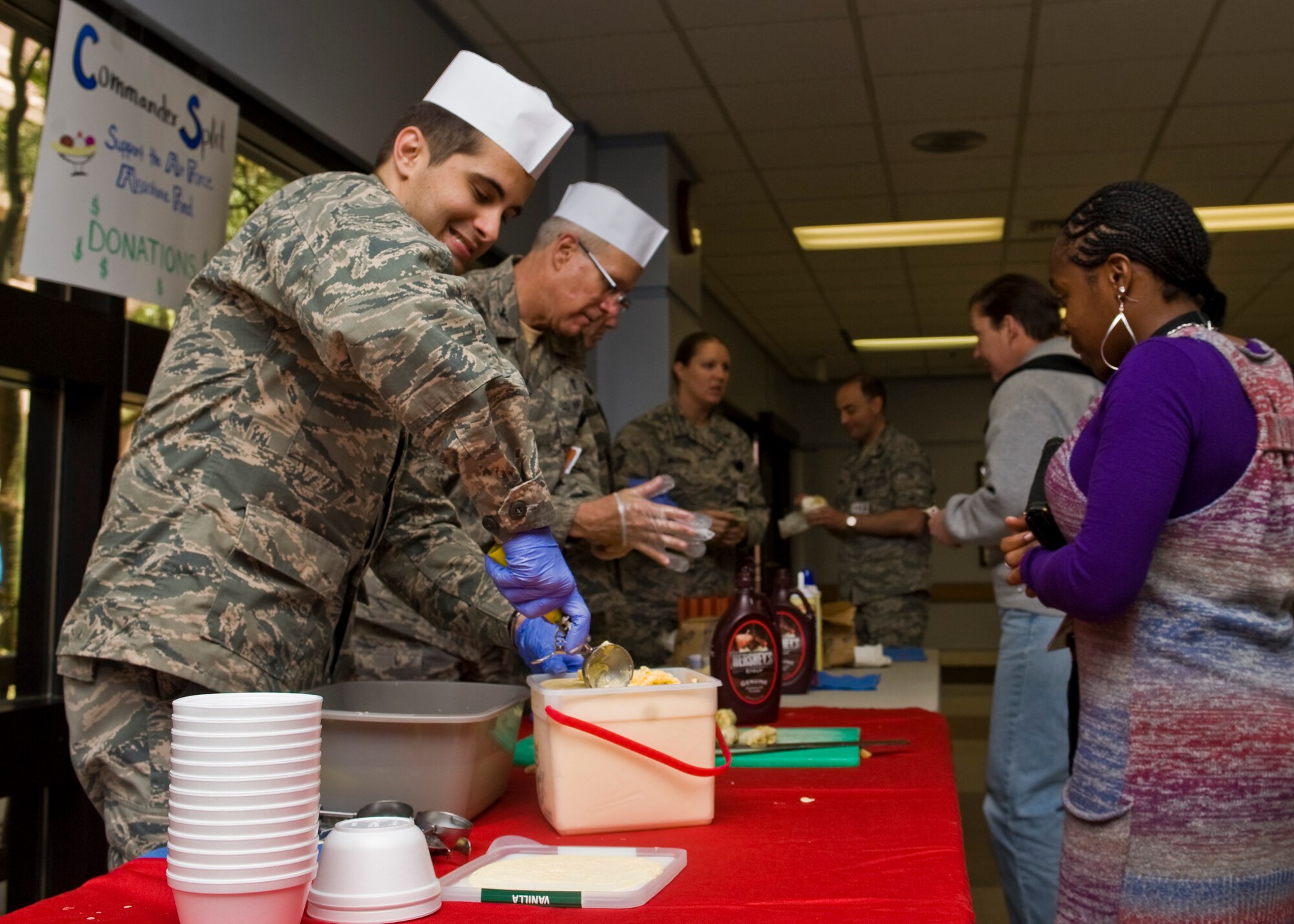 Capt. (Dr.) Wesley Reynolds, 99th Medical Group neurologist, scoops ice cream during the Commander Split fundraiser April 19, 2013, at Nellis Air Force Base, Nev.  The banana split fundraiser lasted from 11:30 a.m. to 1:00 p.m. at the Mike O’Callaghan Medical Center.  The medical staff raised approximately $350 for the Air Force Assistance Fund. (U.S. Air Force Photo by Airman 1st Class Jason Couillard) 