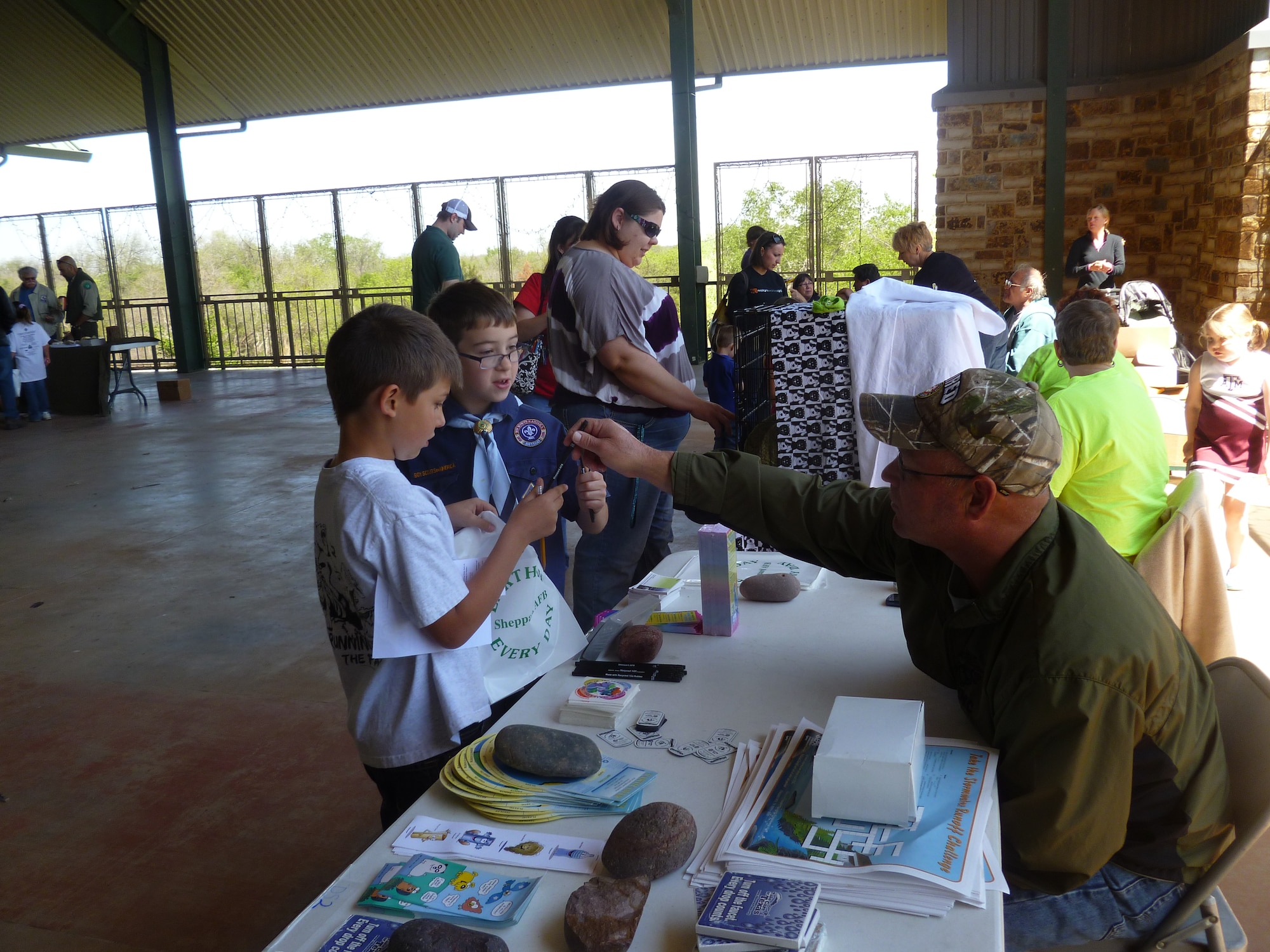 Tom Minton, an Environmental Technician with the 82nd Civil Engineering Squadron, hands  out Earth Day materials at River Bend Nature Center April 20. The materials were being given out to spread Earth Day awareness to local residents. (U.S. Air Force courtesy photo)