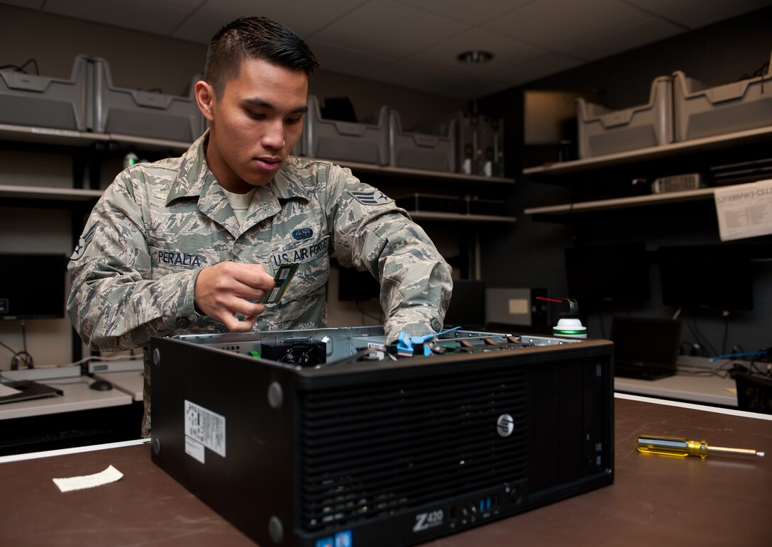 Senior Airman Luis Peralta, 28th Communications Squadron client systems technician, reinstalls a computer’s random access memory cards during scheduled maintenance at Ellsworth Air Force Base, S.D., April 17, 2013. Client systems technicians keep the base’s computer network and systems operating by quickly responding to and resolving computer issues. (U.S. Air Force photo by Airman 1st Class Alystria Maurer/Released)