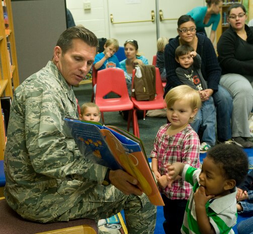 Col. Barry Cornish, 99th Air Base Wing Commander, reads to children at the base library April 17, 2013 at Nellis Air Force Base, Nev., as part of child abuse awareness and prevention month. The outreach is part of an ongoing effort by base commanders to spread the word about keeping an eye out for signs of child abuse. Base leadership recommends working through appropriate offices like the Nellis Family Advocacy Program at 653-3880 or the BOUNCE page on the Nellis website if you have questions. (U.S. Air Force photo/Benjamin Newell)