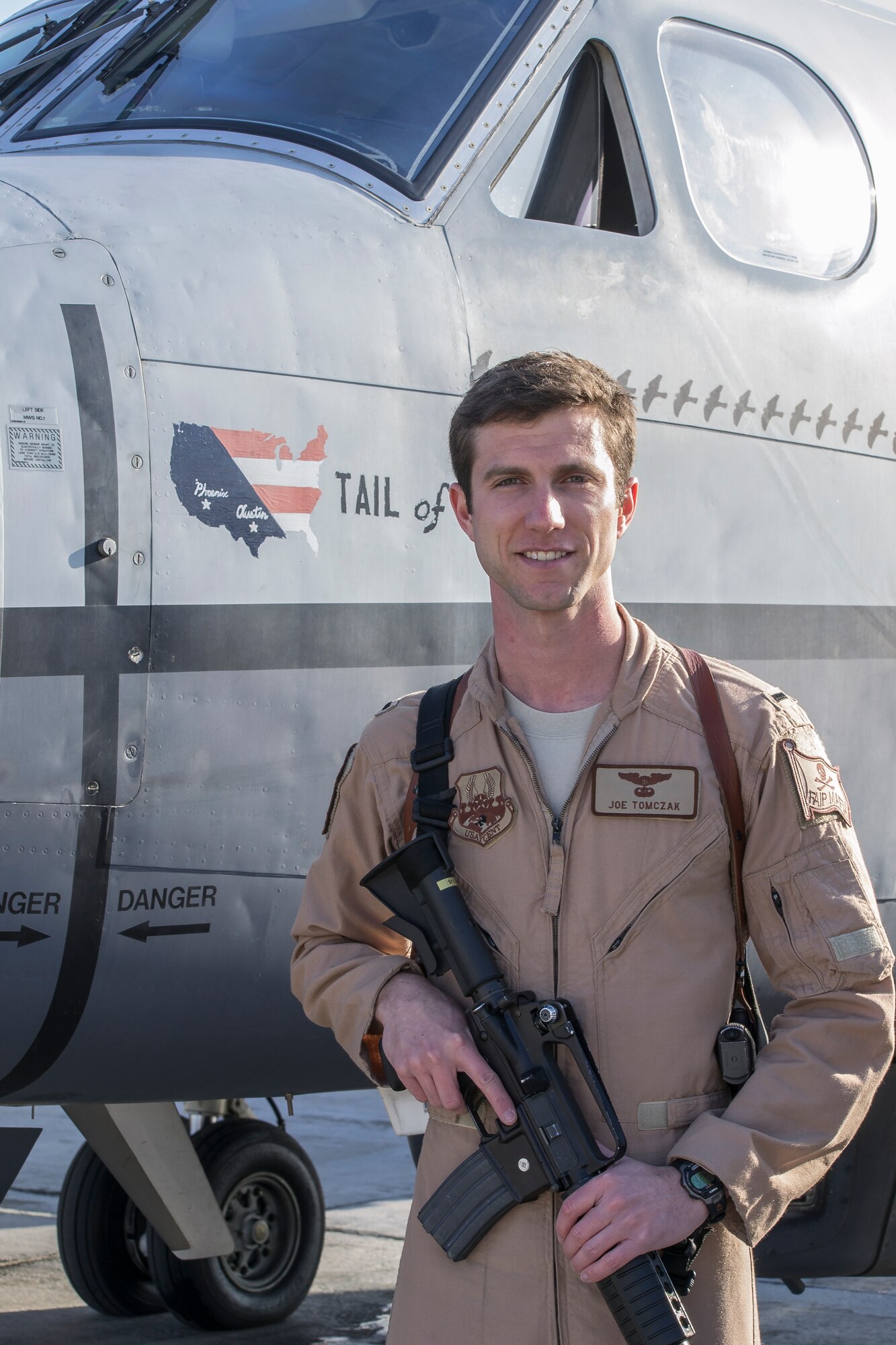 First Lt. Joseph Tomczak, an instructor pilot with the 86th Flying Training Squadron at Laughlin Air Force Base, Texas, poses next to his MC-12W aircraft at Bagram Air Field, Afghanistan, Dec. 1, 2012. Tomczak was deployed to Afghanistan from June 2012 to Jan. 2013, where he served with the 4th Expeditionary Reconnaissance Squadron as a MC-12W mission pilot and assistant flight commander. (Contributed photo)