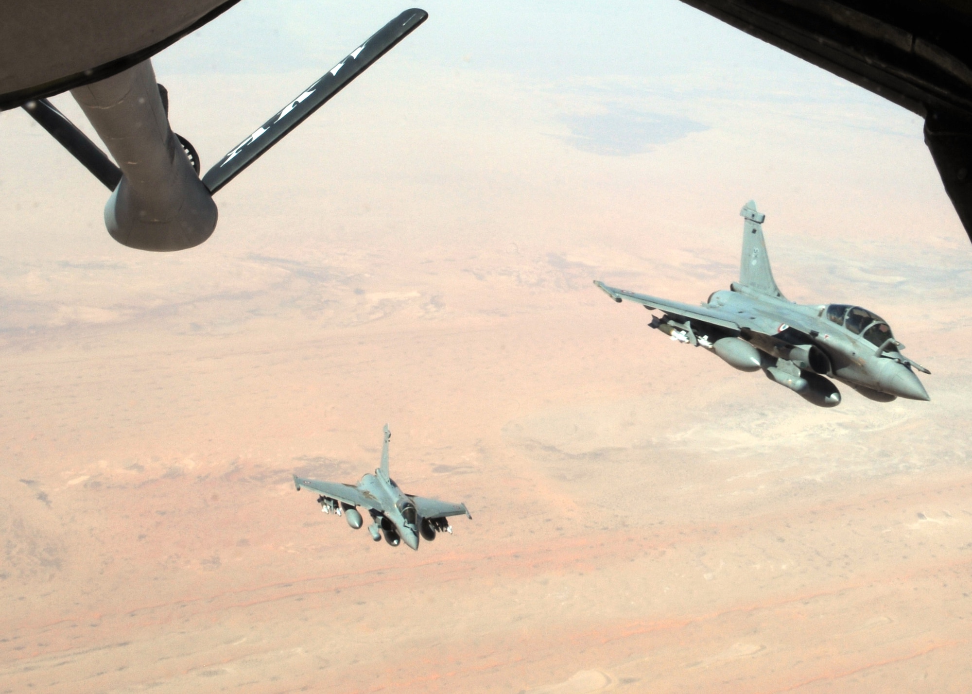 Two French Rafale fighter aircraft break formation after refueling with a KC-135 Stratotanker April 23, 2013, over Mali. The Stratotankers are from the 100th Air Refueling Wing at RAF Mildenhall, England, and are currently operated by the 100th’s forward deployed unit, the 351st Expeditionary Air Refueling Squadron. (U.S. Air Force photo by 1st Lt. Christopher Mesnard/Released)