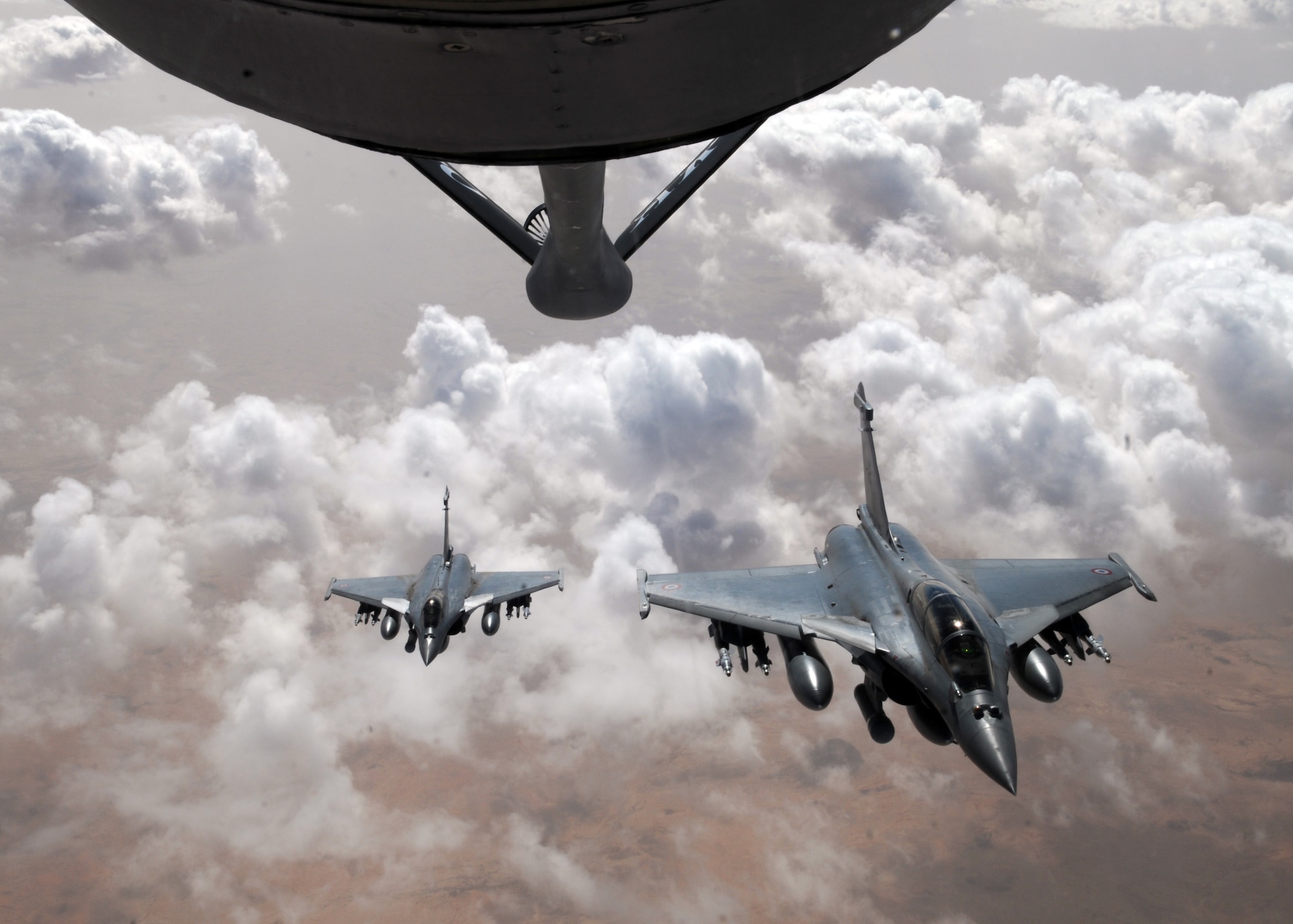 Two French Rafale fighter aircraft prepare to break formation after refueling with a KC-135 Stratotanker April 23, 2013, over Mali. The Stratotankers are from the 100th Air Refueling Wing at RAF Mildenhall, England, and are currently operated by the 100th’s forward deployed unit, the 351st Expeditionary Air Refueling Squadron. (U.S. Air Force photo by 1st Lt. Christopher Mesnard/Released)