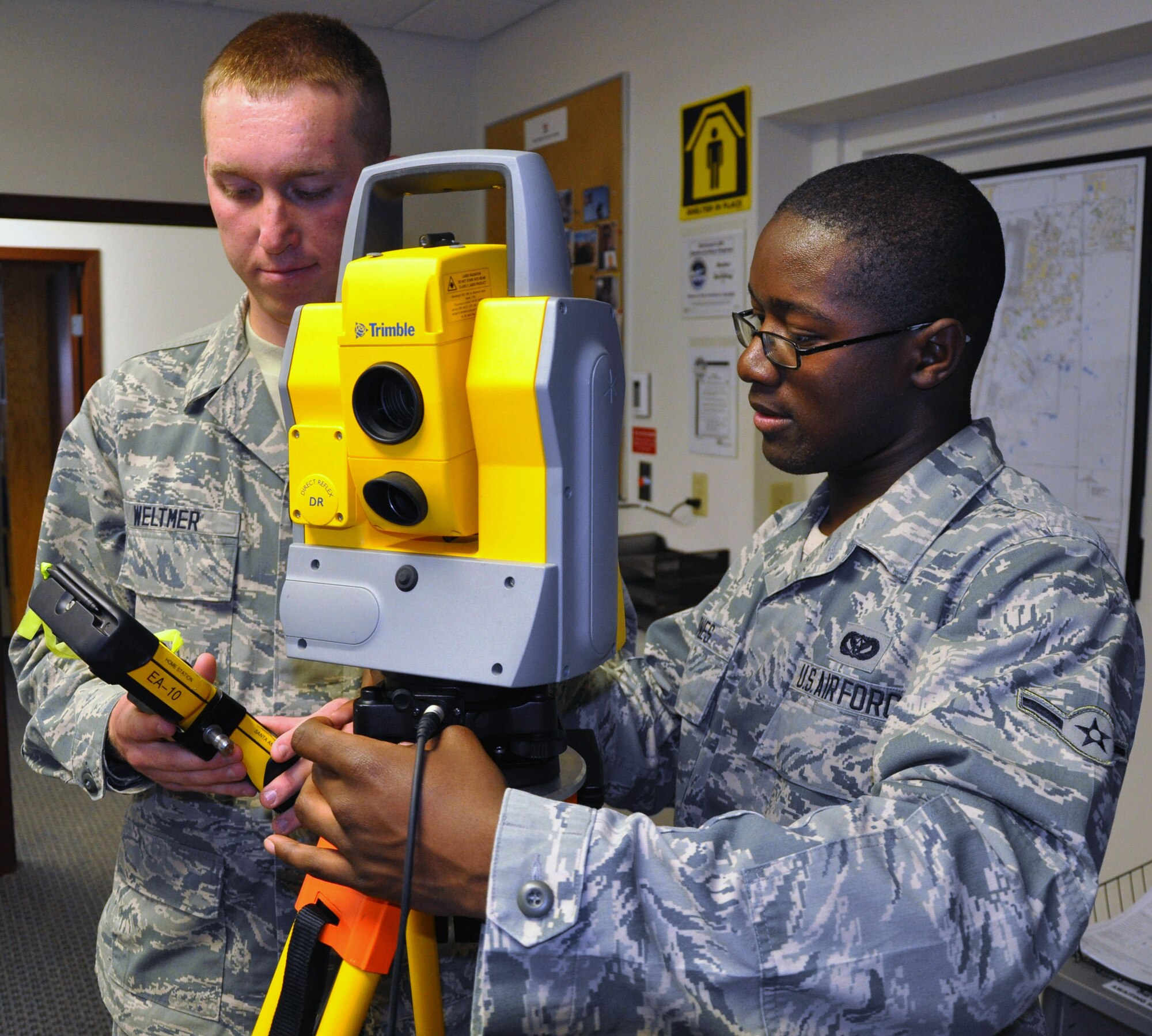 Airman Chase Weltmer and Airman Jalen Jones, engineering assistants assigned to the Air Force Reserve 931st Civil Engineer Squadron, demonstrate the operation of a "Total Optical Station" at McConnell Air Force Base, Kan., April 23, 2013.  The Total Optical Station is used by civil engineers to ensure correct elevations and angles for structures.  (U.S. Air Force photo by Capt. Zach Anderson)