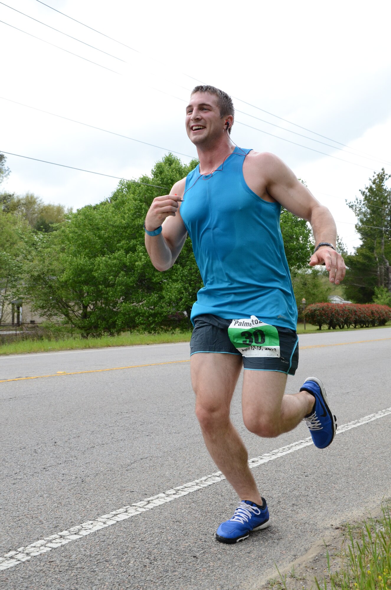 U.S. Air Force 1st Lt. Christopher Thomas, 20th Comptroller Squadron financial services officer, continues his run after receiving water and motivation from teammates standing by during the Palmetto 200 relay race, April 12, 2013, Santee, S.C. The Road Warriors Running Club at Shaw Air Force Base took part in the overnight relay from Columbia, S.C., to Charleston, S.C., earning a time of 29:13:00 and ranking 25th overall. (U.S. Air Force photo by 2nd Lt. Earon E. Brown/Released)