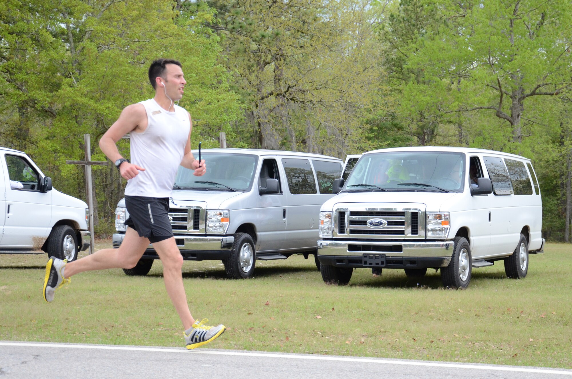 U.S. Air Force Maj. Joshua Wennrich, 20th Equipment Maintenance Squadron commander, prepares to hand off his team’s wristband baton as he approaches an exchange zone for the Palmetto 200 relay race, April 12, 2013, Columbia, S.C. The Road Warriors Running Club at Shaw Air Force Base took part in the overnight relay from Columbia, S.C., to Charleston, S.C., earning a time of 29:13:00 and ranking 25th overall. (U.S. Air Force photo by 2nd Lt. Earon E. Brown/Released)