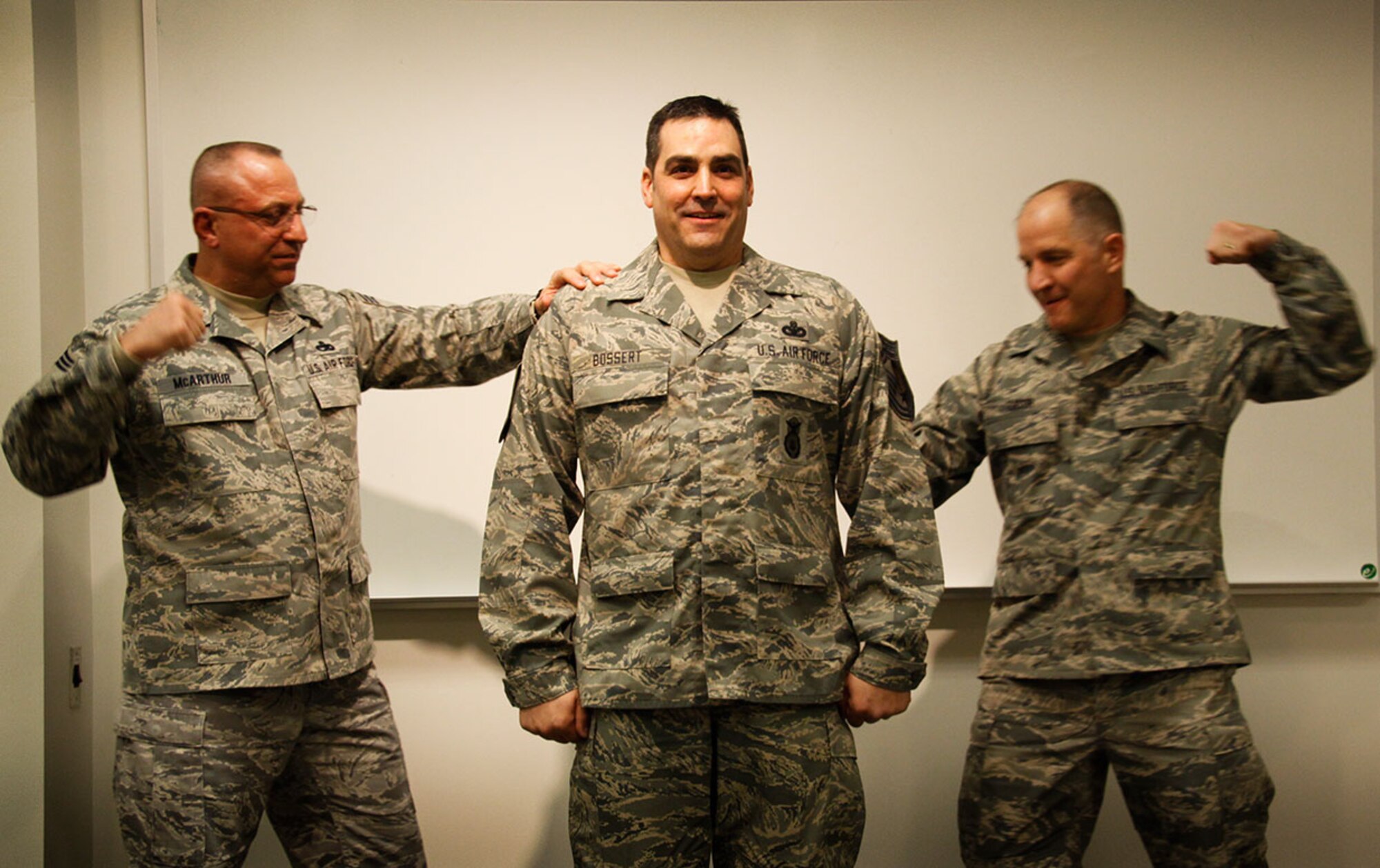 President of the 911th Airlift Wing's Chief Council, Chief Master Sgt. Joe McArthur (left) tack on Chief Master Sgt. Bryan Bossert’s new stripes along with 911th Command Chief Master Sgt. Brian Zator (right), at the Pittsburgh International Airport Air Reserve Station, April 6, 2013. Prior to the promotion Chief McArthur recognized Chief Bossert, in front of family, friends, and fellow Airmen, for achieving the pinnacle of the enlisted ranks and his dedication to the unit, Air Force and his country. (U.S. Air Force photo by Senior Airman Justyne Obeldobel/Released)
