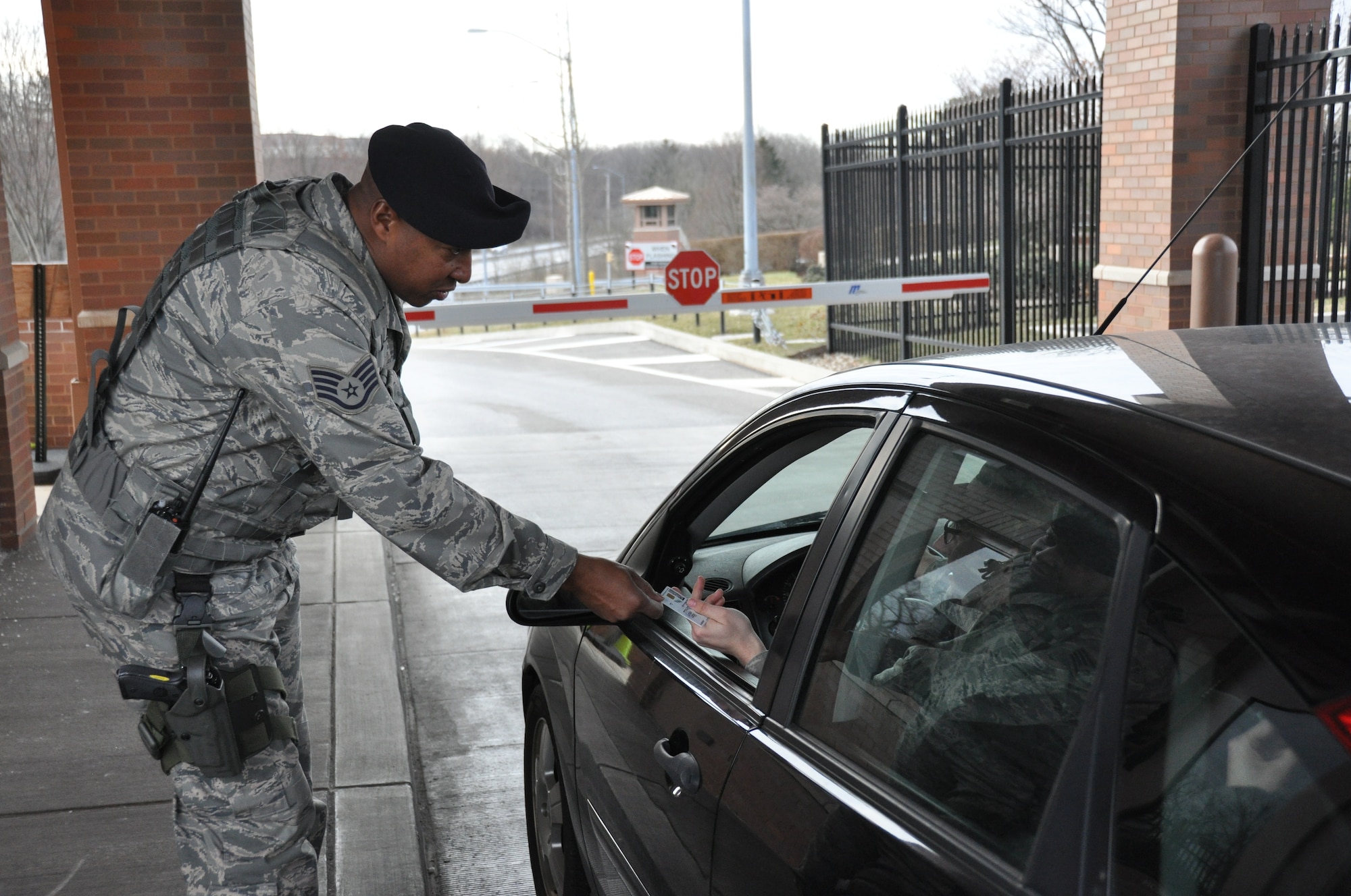Staff Sgt. Marvin R. Harris, 911th Airlift Wing Security Forces patrolman, checks a driver’s identification card before granting access to the base, April 6, 2013. Recently the Security Forces base access procedures resulted in three arrests, and two denials of entry onto the base. Working in partnership with local law enforcement, three individuals were detained and arrested for prosecution under Pennsylvania state laws. Security Forces inspect all delivery and construction vehicles entering the base.  (U.S. Air Force photo by Senior Airman Joseph E. Bridge/Released)