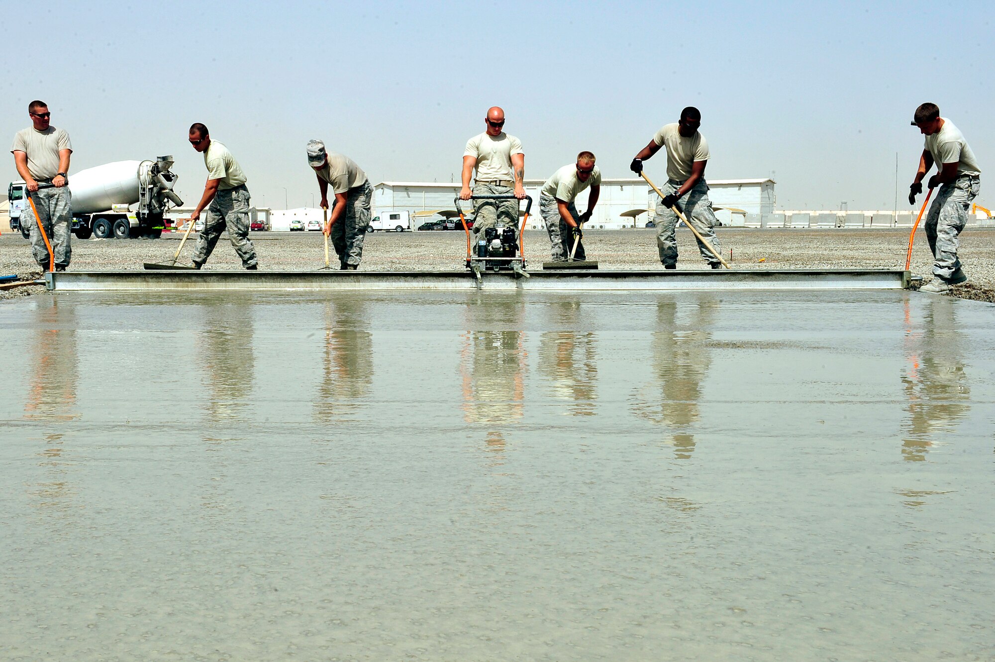 U.S. Air Force Airmen assigned to the 380th Expeditionary Civil Engineer Squadron known as "Dirt Boyz" lay concrete pads at an undisclosed location in Southwest Asia April 16, 2013. The "Dirt Boyz" have dug trenches, poured 96 concrete pads, and set up t-walls, throughout the installation to aid in the 380th Air Expeditionary Wing's transition from expeditionary to enduring. (U.S. Air Force photo by Tech. Sgt. Christina M. Styer)