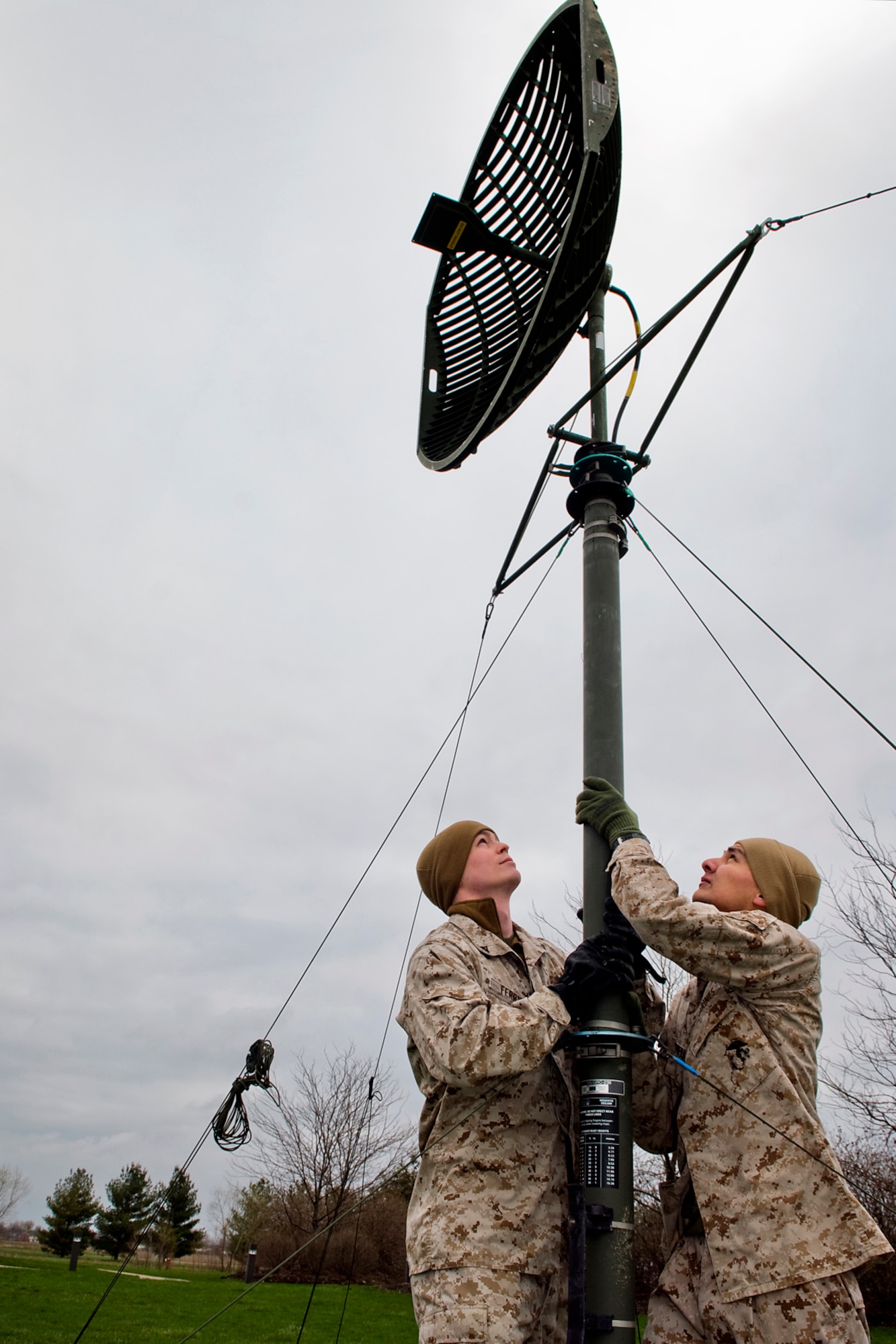 GRISSOM AIR RESERVE BASE, Ind. - Lance Cpl. Brett Ferry and Cpl. Luis Barrera, both Detachment 1, Communications Company, Headquarters and Service Battalion, 4th Marine Logistics Group field radio operators, work on setting up an antenna during a communication exercise here April 13. The exercise was held to help validate the Marines equipment capabilities as well as prepare them for a larger-scale this summer at Camp Lejeune, N.C. (U.S. Air Force photo/Staff Sgt. Ben Mota)
