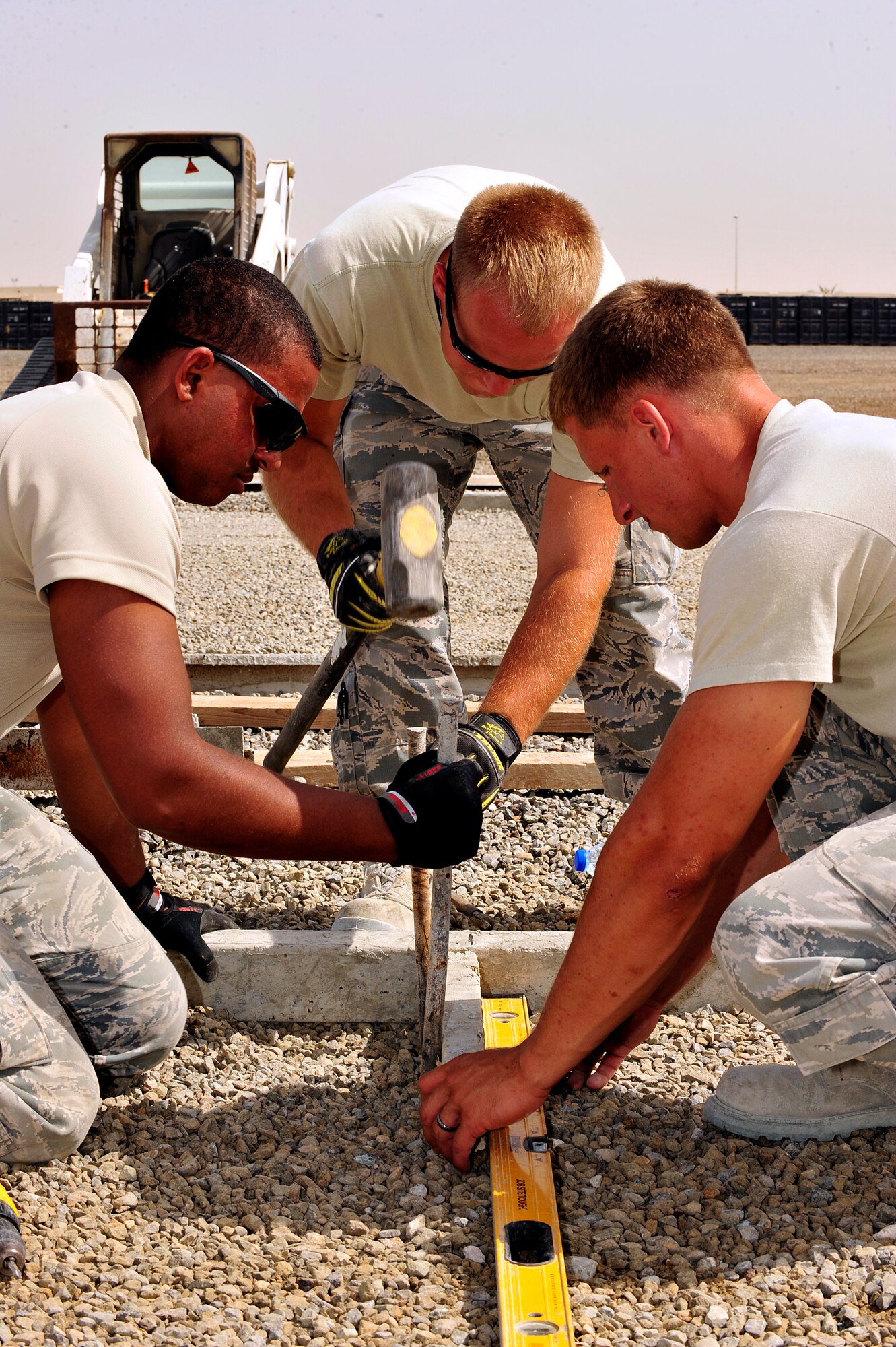 U.S. Air Force Senior Airmen David Vaughner and Daniel Bulla and Airman 1st Class Jacob Kokinda, 380th Air Expeditionary Wing pavement and construction equipment journeymen, prepare to pour concrete pads at an undisclosed location in Southwest Asia April 16, 2013. The "Dirt Boyz" have laid 96 pads to aide in the transition from expeditionary to enduring. Vaughner is deployed from Mountain Home Air Force Base, Idaho, and Bulla and McCarthy are deployed from Eielson AFB, Alaska. (U.S. Air Force photo by Tech. Sgt. Christina M. Styer)