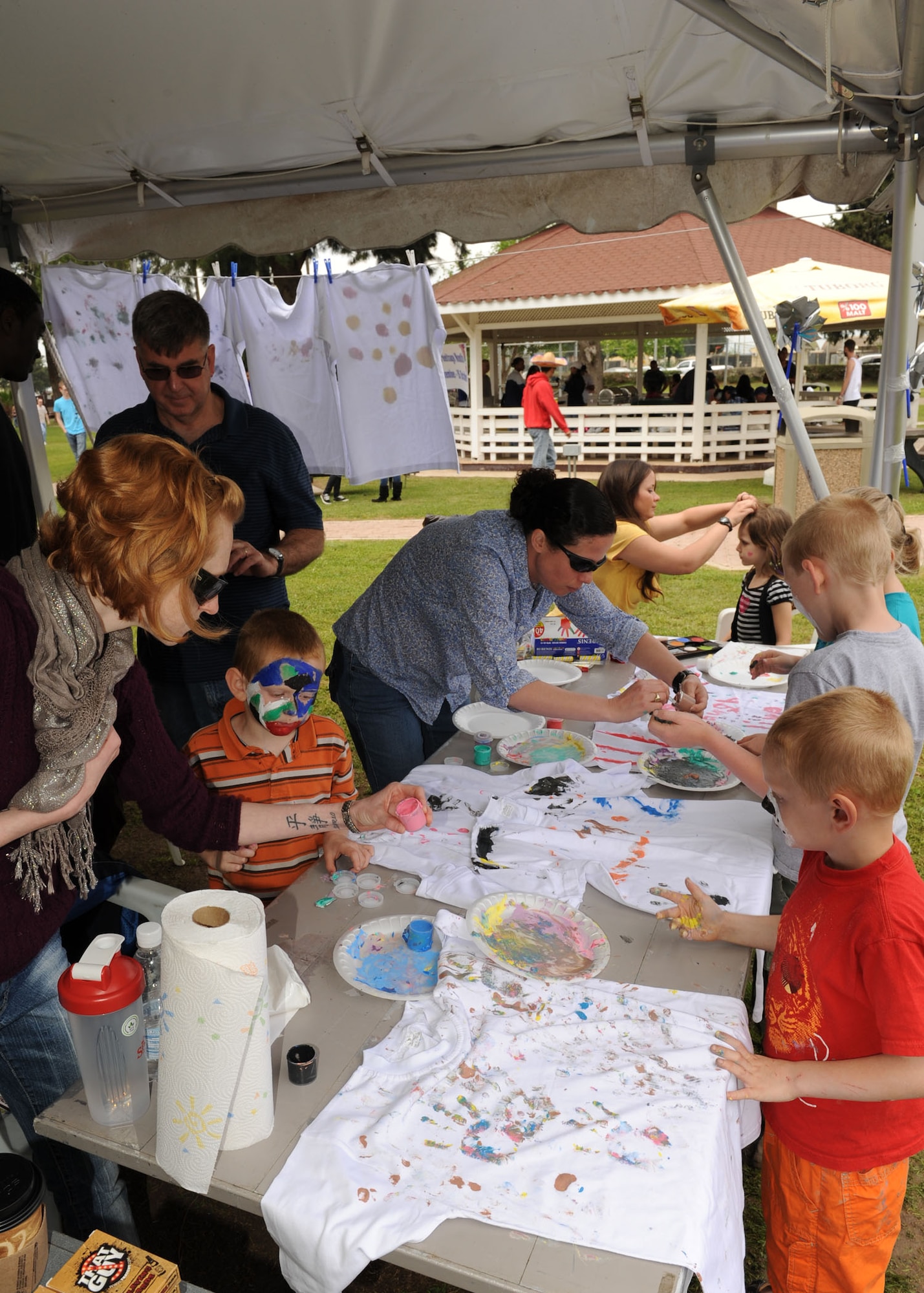 Children finger-paint t-shirts at a table sponsored by the 39th Medical Group mental health clinic at the Spring Fling celebration April 20, 2013, at Incirlik Air Base, Turkey. The kid’s corner, bouncy castles and additional entertainment offered attendees of all ages a variety of activities to participate in. (U.S. Air Force photo by Senior Airman Chase Hedrick/Released)