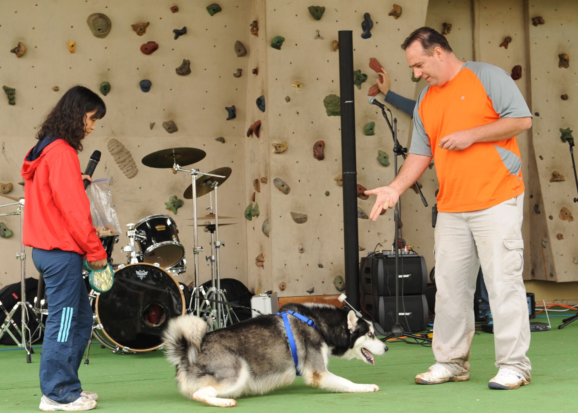 Grace Grothues holds her dog Koda as her husband Marcus Grothues gives their pet the signal to play dead during the pet tricks contest at the Spring Fling April 20, 2013, at Incirlik Air Base, Turkey. The Spring Fling is an annual celebration at Incirlik Air Base to welcome the warmer seasons. (U.S. Air Force photo by Senior Airman Chase Hedrick/Released)