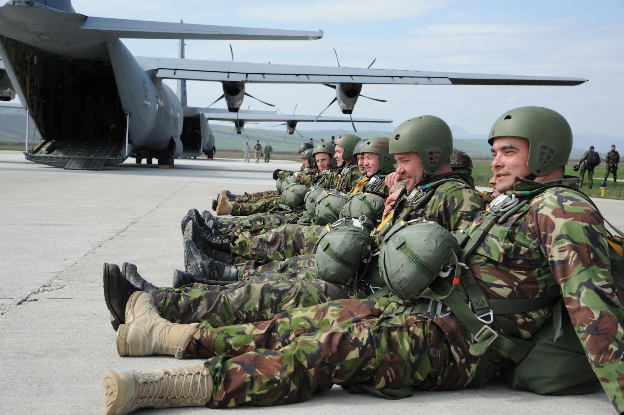 Romanian paratroops sit in formation before boarding a C-130J Super Hercules during Exercise Carpathian Spring, April 16, 2013, Bucharest, Romania. The exercise was designed for aircrew to receive upgrade training as well as building partnership capacity with Romanians. (U.S. Air Force photo/Airman 1st Class Hailey Haux)