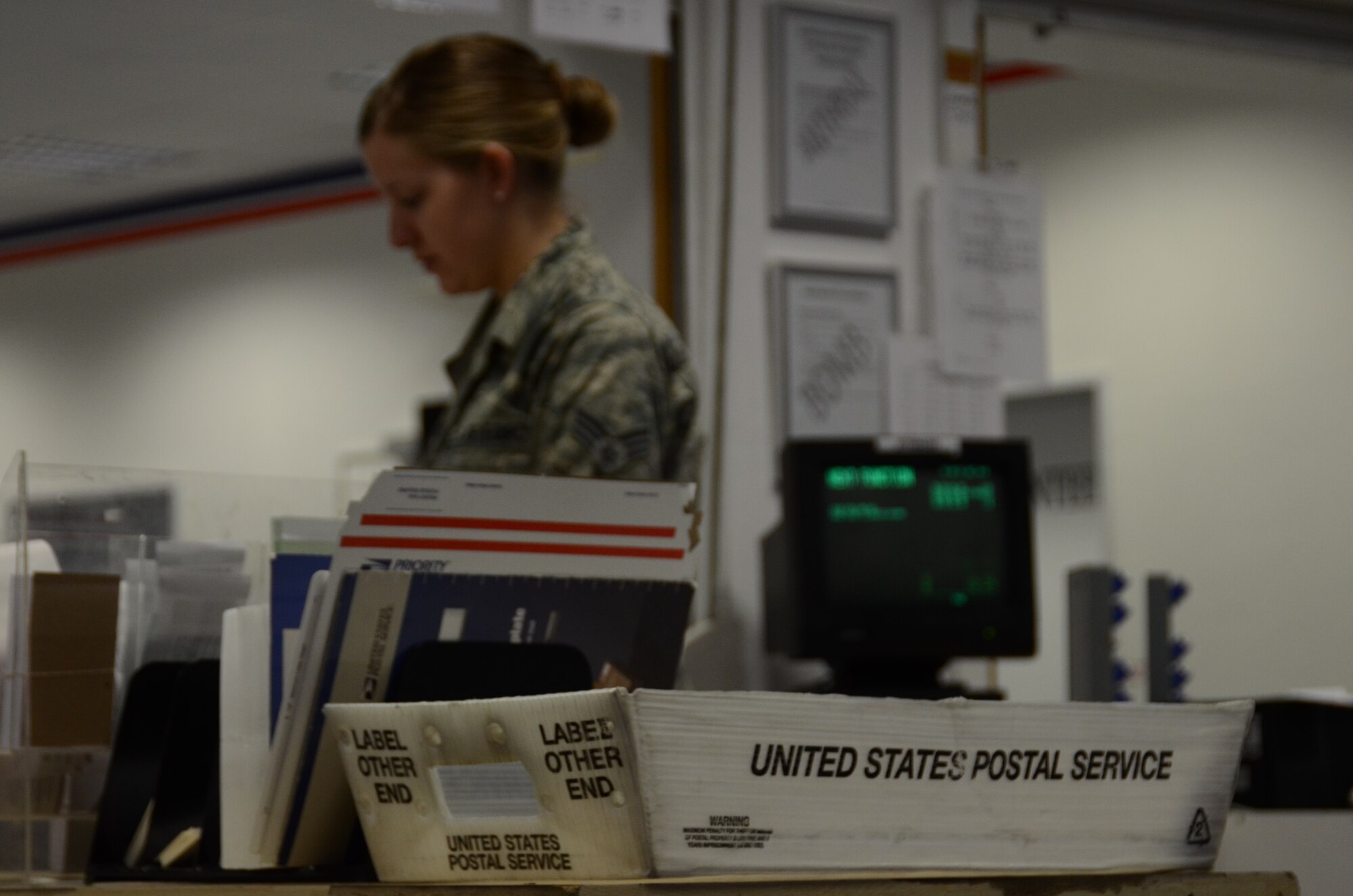An 86th Communications Squadron Airman works in the finance section at the North Side Post Office during a visit from United States Postal Service inspectors April 19, 2013, Ramstein Air Base, Germany. The USPS inspectors visited the North Side Post Office to observe the day-to-day functions of the Department of Defense's largest postal operation. (U.S. Air Force photo / 2nd Lt. Kay M. Nissen)
