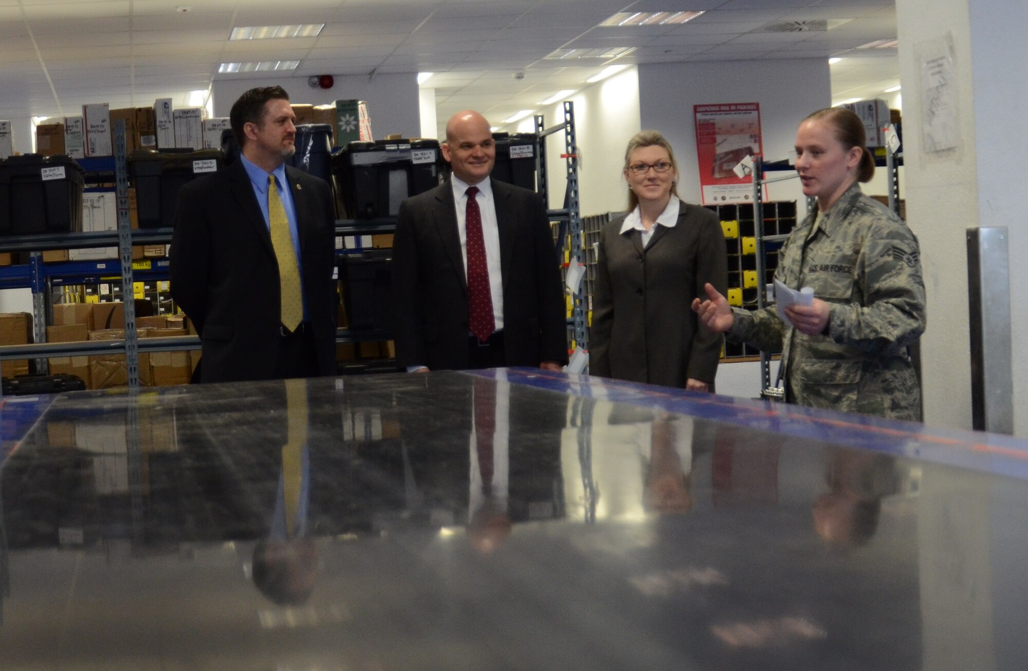 Senior Airman Chelsea Kemper, North Side Post Office custodian of postal
effects, briefs United States Postal Service inspectors on the parcel
service center April 19, 2013, Ramstein Air Base, Germany. The USPS
inspectors visited the North Side Post Office to observe the day-to-day
functions of the Department of Defense's largest postal operation. (U.S. Air
Force photo / 2nd Lt. Kay M. Nissen)
