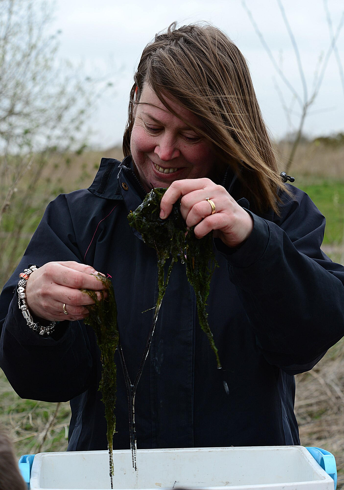 ROYAL AIR FORCE LAKENHEATH, England— Claire Bushnell, defence infrastructure organisation environmental manager, holds-up frog spawns for a third grade class to see during a pond dipping activity at Defenders Park April 18, 2013. A third grade class from RAF Lakenheath Elementary School examined the algae they collected and tried to identify the different pond creatures. (U.S. Air Force photo by Staff Sgt. Stephanie Mancha)