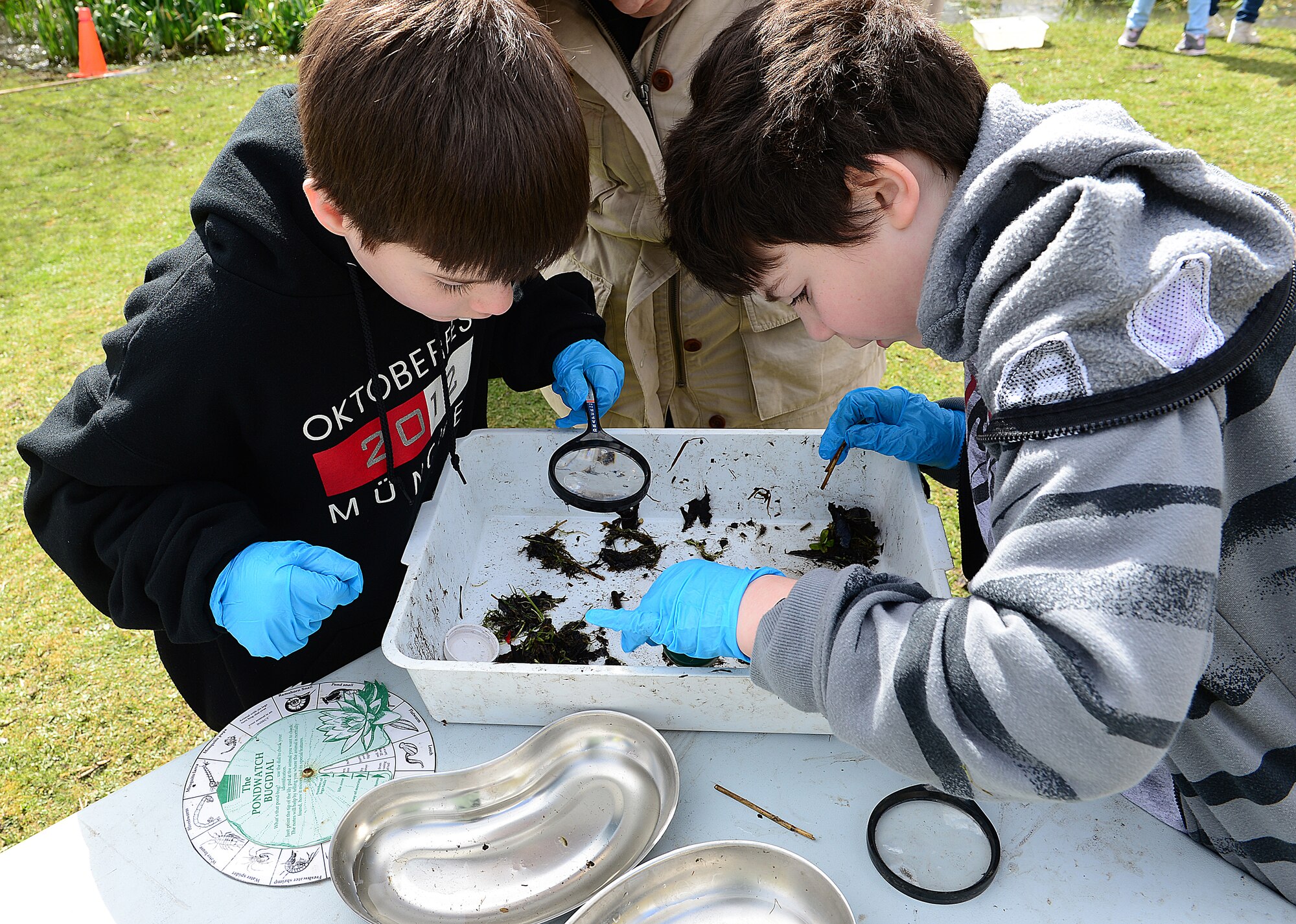 ROYAL AIR FORCE LAKENHEATH, England— Duncan Norwood, son of Maj. David Norwood 48th Medical Surgical Squadron, and Jonathan VanHouten, son of Master Sgt. Andrew VanHouten, 48th Fighter Wing, examine pond shrimp that they collected at Defenders Park during a pond dipping activity for Earth Week, April 18, 2013.  A third grade class from RAF Lakenheath elementary school participated in a pond dipping activity in support of Earth Day. The children looked through algae they collected for pond creatures. (U.S. Air Force photo by Staff Sgt. Stephanie Mancha)