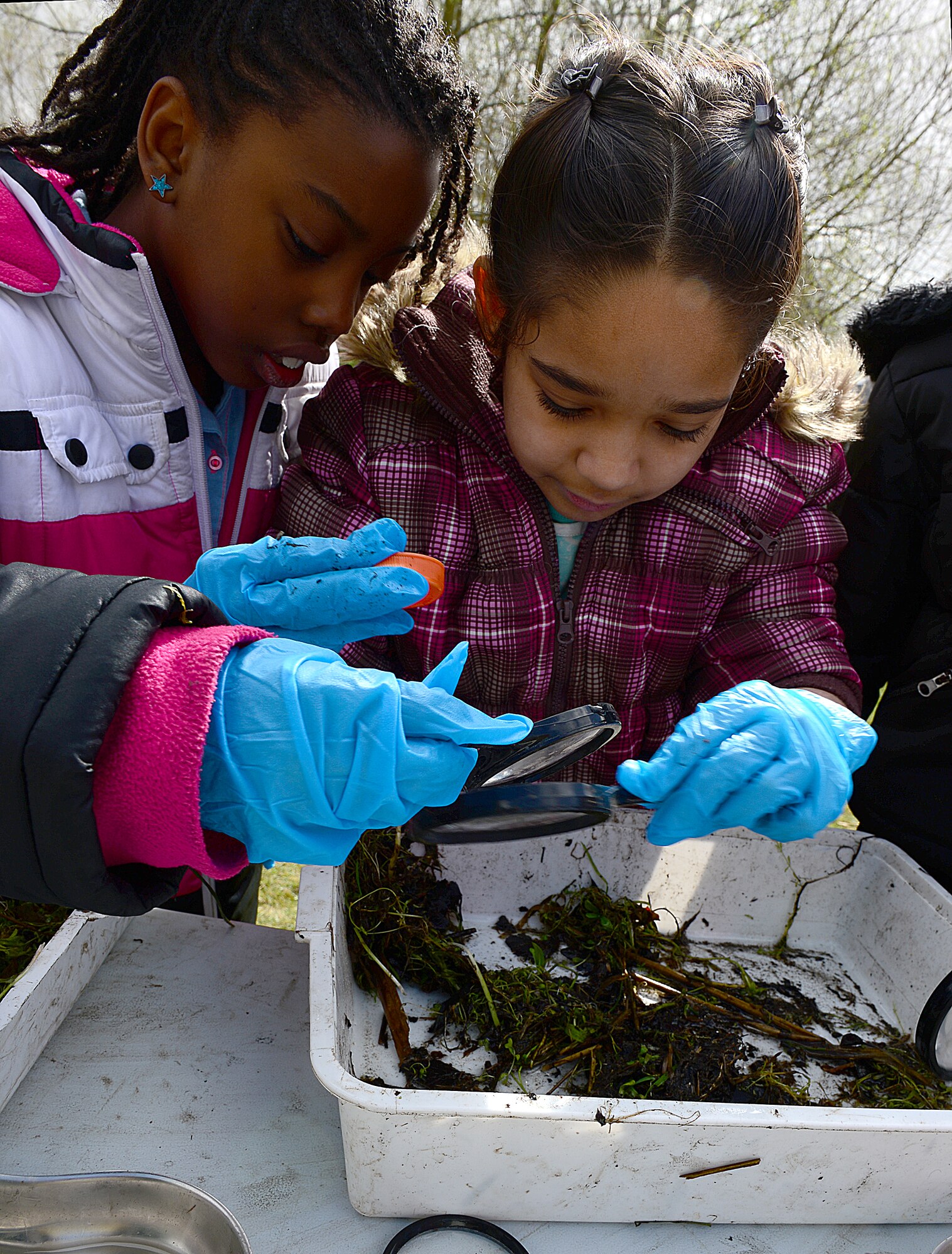 ROYAL AIR FORCE LAKENHEATH, England—Aleya McCoy (left), daughter of Staff Sgt. Jakeith Robinson, 48th Force Support Squadron, and Rebecca Carrasquillo, daughter of Raymond Carrasquillo, 352nd Special Operations Maintenance Squadron, RAF Mildenhall, search for pond life at Defenders Park during a pond dipping activity for Earth Week, April 18, 2013. Earth Day is an annual event held worldwide to show support for environmental protection.  RAF Lakenheath held several events in support of Earth Day, which was observed on April 22. (U.S. Air Force photo by Staff Sgt. Stephanie Mancha)