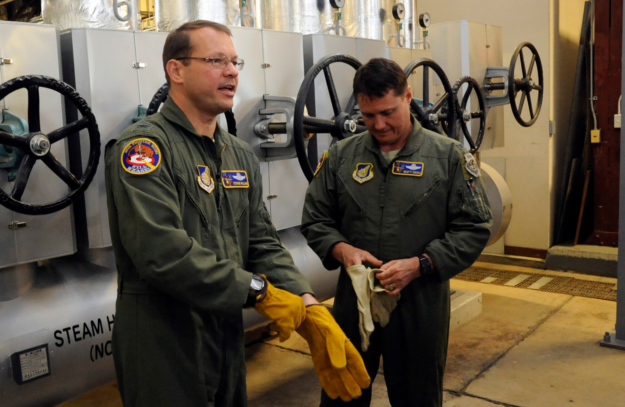 U.S. Air Force Col. Stephen Williams, 35th Fighter Wing commander, and Col. Matthew Dana, 35 FW vice commander prepare to shut off the steam lines that heat the industrial buildings seven days early at Misawa Air Base, Japan, April 24, 2013. Shutting the heat off early could potentially save the base 91,000 gallons of fuel used to heat the buildings and approximately $333,970. (U.S. Air Force photo by Airman 1st Class Kaleb Snay) 
