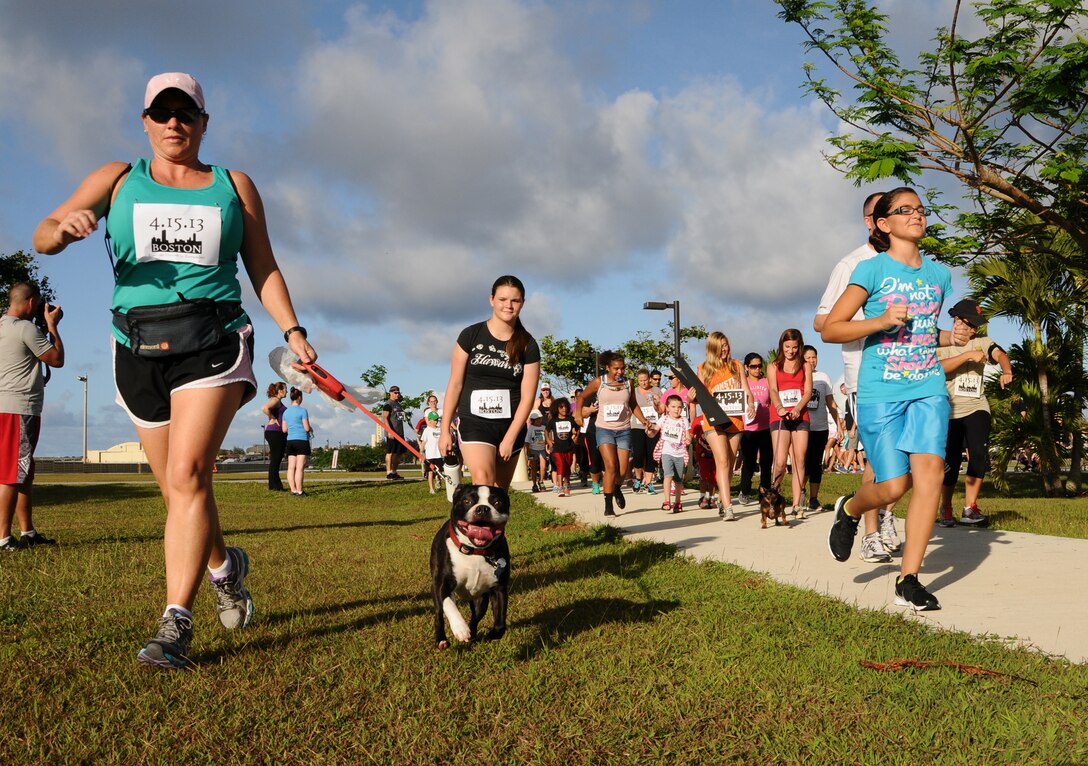 Members of Team Andersen run with family, friends, and pets during the Run 4 Boston memorial event on Andersen Air Force Base, Guam, April 21, 2013.  Participants were encouraged to complete at least one lap of the .79-mile route in remembrance of the victims of the Boston Marathon bombing. (U.S. Air Force photo by Airman 1st Class Emily A. Bradley/Released)