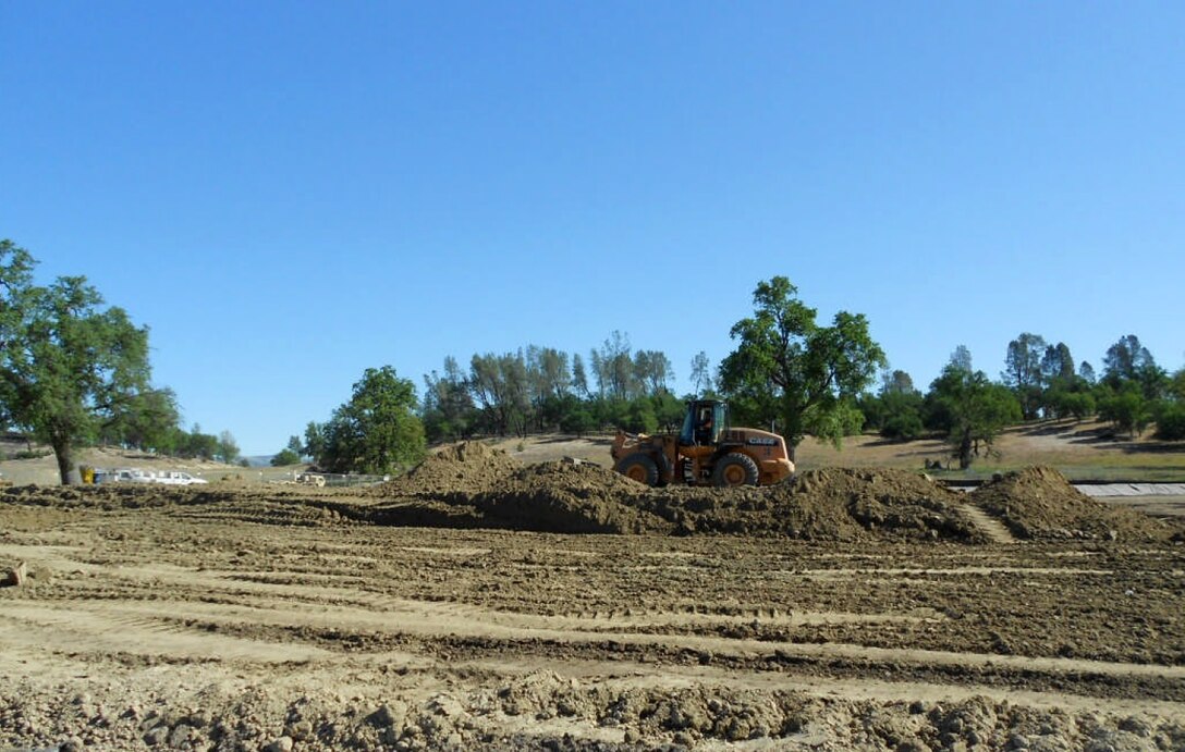 A contract worker spreads gasoline-contaminated soil at Fort Hunter Liggett, Calif., April 17, 2013 to allow the sun to naturally evaporate the contaminants. The sustainable remediation process, called landfarming, is part of an environmental restoration project at the installation managed  by the U.S. Army Corps of Engineers Sacramento District.