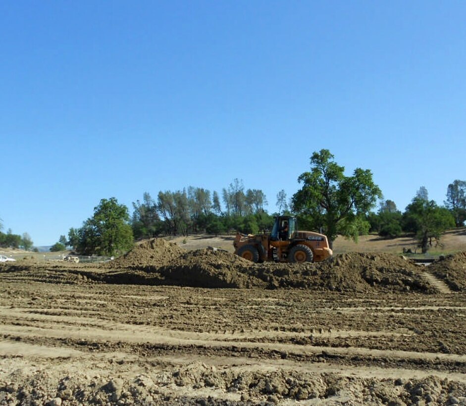 A contract worker spreads gasoline-contaminated soil at Fort Hunter Liggett, Calif., April 17, 2013 to allow the sun to naturally evaporate the contaminants. The sustainable remediation process, called landfarming, is part of an environmental restoration project at the installation managed  by the U.S. Army Corps of Engineers Sacramento District.