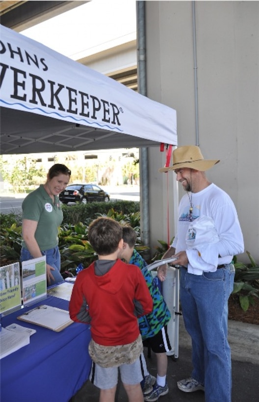 After volunteering for the St. Johns River Cleanup in Jacksonville, Fla. March 16, community members stopped by the Riverside Arts Market, where biologist Jessica Spencer (left) provided information about invasive species located in Florida. 