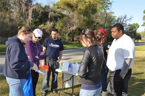 Biologist Jessica Spencer (left) educates a volunteer group about air potato, an invasive vine that has been found at local creek cleanups. The volunteers were at one of many cleanup sites around Jacksonville, Fla. as part of the 18th Annual St. Johns River Cleanup March 16. 