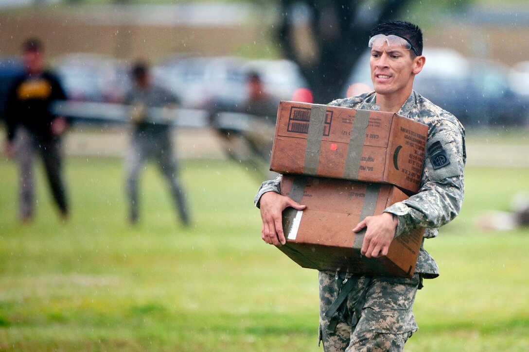 Army Staff Sgt. Anthony Vasquez moves weighted boxes as part of a sling load recovery event during the final day of the 30th annual Best Ranger Competition on Fort Benning, Ga., April 14, 2013. Vasquez is assigned to the 4th Infantry Division.