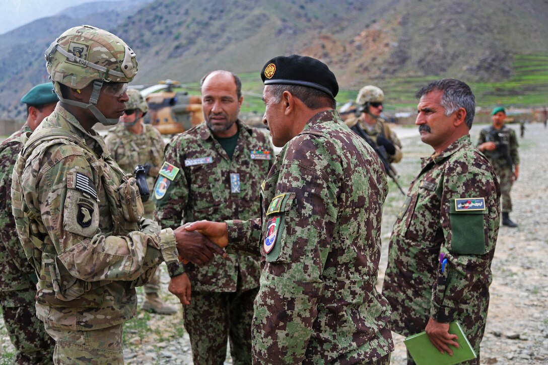 U.S. Army Brig. Gen. Roland F. Lewis, left, Deputy Commanding General for Support, arrives on Forward Operating Base Bostic, Kunar province, Afghanistan, April 19, 2013. Lewis attended a meeting to discuss enemy operations in the area.