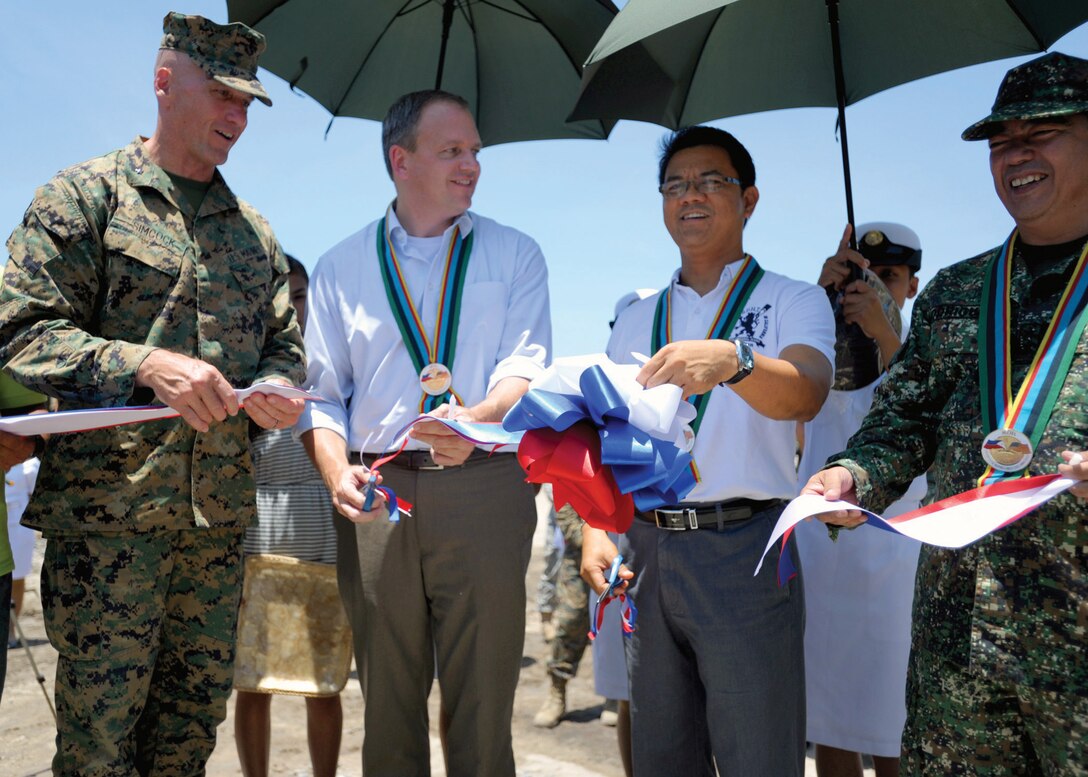 From the left, U.S. Marine Corps Brig. Gen. Richard Simcock, Steve Weston, Ramon Lacbain and Philippine Navy Rear Adm. Jose M. Rodriguez cut a ceremonial ribbon to officially open the new San Pascual footbridge April 14 in the San Narciso municipality, Zambales, Republic of the Philippines. The footbridge was one of seven engineering-civic assistance projects completed by the combined joint civil military operations task force in support of Exercise Balikatan 2013. Balikatan is an annual bilateral training exercise designed to increase interoperability between the Armed Forces of the Philippines and the U.S. military. Simcock is the exercise deputy director for Balikatan 2013. Weston is a representative from the U.S. Embassy in Manila. Lacbain is the vice governor of Zambales. Photo by Petty Officer 1st Class Chris Fahey