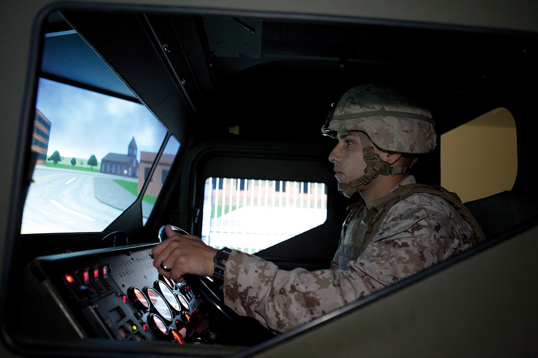 Sgt. Jonathan D. Vanburen trains in a 7-ton truck simulator at the III Marine Expeditionary Force motor vehicle simulator facility April 23 at Camp Hansen. Vanburen is a maintenance management specialist with 2nd Battalion, 4th Marine Regiment.  Photo by Lance Cpl. Anne K. Henry