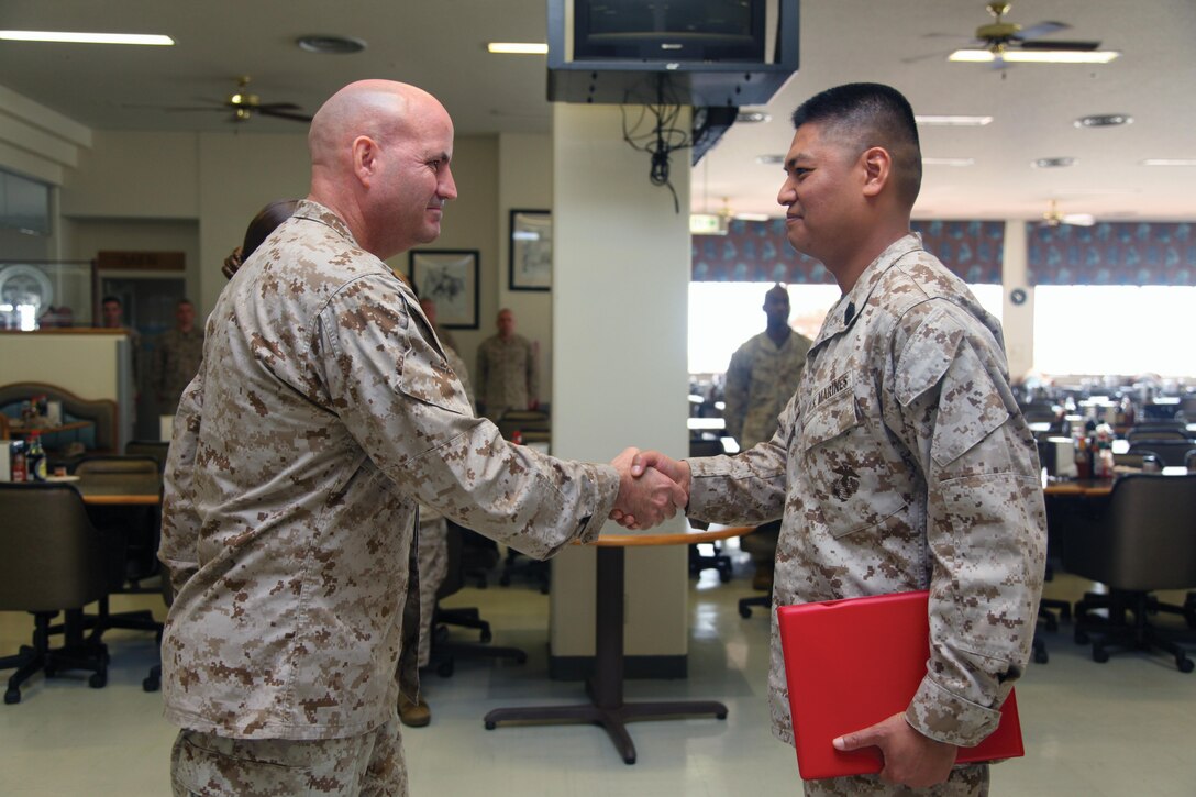 Col. Richard D. Hall, left, congratulates Master Sgt. Vichien Sornchan April 24 at Camp Schwab for he and his Marines’ efforts in earning honors as large mess hall of the quarter for the second quarter of fiscal year 2013. As of the second quarter of FY 2013, mess halls are now separated into two categories for the competition. To win large mess hall of the quarter, a mess hall has to be able to seat more than 400 people. “This is a tough and demanding job which requires long hours of work, but these Marines continue to perform it with professionalism and pride,” said Hall, the commanding officer of 4th Marine Regiment, 3rd Marine Division, III Marine Expeditionary Force, and Camp Schwab commander. Sornchan is the Camp Schwab mess hall manager with Headquarters Company, 4th Marines. Photo by Cpl. Matthew Manning