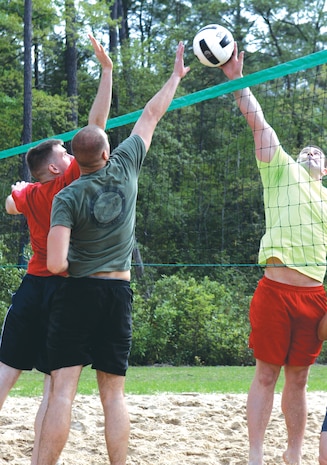 Marines goes up for the block during the 2013 Commander's Cup Volleyball Tournament, April 19. 