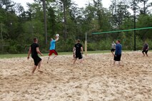A Marine from Headquarters and Headquarters Squadron serves a volleyball during a game at the Commander's Cup volleyball game, April 19. 