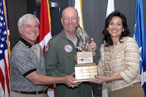 Gen. Gene Renuart, center, commander of North American Aerospace Defense Command and U.S. Northern Command, and Kirk Brown, NORAD and USNORTHCOM Combined Federal Campaign chairperson, accept the CFC Regional Excellence Award from Pikes Peak CFC Regional Director Barbara Fitz during a ceremony at command headquarters Jan. 7, 2008. The commands earned the award by increasing their percentage of participants more than any other agency in the region's 2007 Combined Federal Campaign. The commands also raised five thousand dollars more than their goal of $203,000. Directorates in the commands received 14 gold, one silver and one bronze award for their CFC donations, and Brown and Air Force Capt. Mark Walker both received CFC Hero Awards. Brown also was designated as the CFC Regional Civilian Hero and is now eligible for national recognition. During the same time period as CFC, Canadian servicemembers in NORAD raised $21,000 for the Canadian National Defence Workplace Charitable Campaign. Photo by Sgt. 1st Class Gail Braymen 