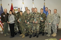 The North American Aerospace Defense Command and U.S. Northern Command 4th quarter award winners are, front row, left to right: Joyce Frankovis, Marine Corps Staff Sgt. Jaime Viramontes, Air Force Capt. Mark Walker, Air Force Lt. Col. William Alvey, Air Force Maj. Valerie Long and NORAD and USNORTHCOM Command Senior Enlisted Leader Command Sgt. Maj. Daniel Wood. Back row, left to right: NORAD and USNORTHCOM Commander Gen. Gene Renuart, Air Force Staff Sgt. Christopher Newcomer, Air Force Master Sgt. Scott Bergeski, Gunnery Sgt. Shawn Moran, Army Capt. Richard Szabo, Air Force Lt. Eric Astle and Roy Stanley. Not pictured are Army Maj. Patrice Harris and Scot Southard.