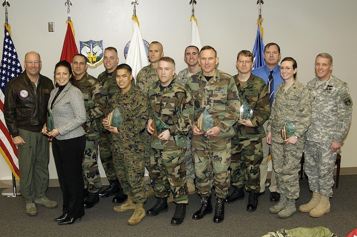 The North American Aerospace Defense Command and U.S. Northern Command 4th quarter award winners are, front row, left to right: Joyce Frankovis, Marine Corps Staff Sgt. Jaime Viramontes, Air Force Capt. Mark Walker, Air Force Lt. Col. William Alvey, Air Force Maj. Valerie Long and NORAD and USNORTHCOM Command Senior Enlisted Leader Command Sgt. Maj. Daniel Wood. Back row, left to right: NORAD and USNORTHCOM Commander Gen. Gene Renuart, Air Force Staff Sgt. Christopher Newcomer, Air Force Master Sgt. Scott Bergeski, Gunnery Sgt. Shawn Moran, Army Capt. Richard Szabo, Air Force Lt. Eric Astle and Roy Stanley. Not pictured are Army Maj. Patrice Harris and Scot Southard.