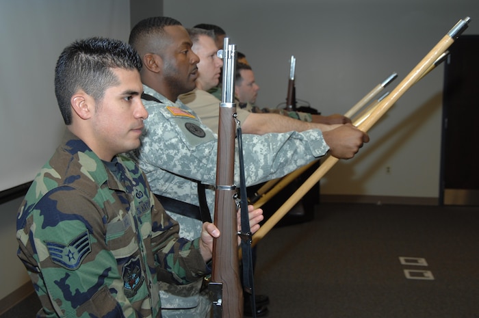 Staff Sgt. Sean Arce, a member of the NORAD and USNORTHCOM Joint Color Guard rehearses present arms recently. The Joint Color Guard has been chosen to represent the nation's armed forces during opening ceremonies for Super Bowl XLII Jan. 3, in Phoenix, Ariz. Photo by Petty Officer 1st Class Joaquin Juatai 