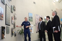 Department of Homeland Security officials stop at the 9-11 tribute wall during a visit to the headquarters of North American Aerospace Defense Command and U.S. Northern Command on Feb. 25, 2008. From left to right are Coast Guard Rear Adm. Dan Lloyd, DHS military advisor; Brian White, DHS chief of staff to deputy secretary; Chad Sweet, DHS chief of staff; and Fred Schwien, DHS executive secretary/executive director for operations and administration. The group came to the commands to meet key staff members and discuss mutual civil support and homeland defense issues. Photo by Sgt. 1st Class Gail Braymen 