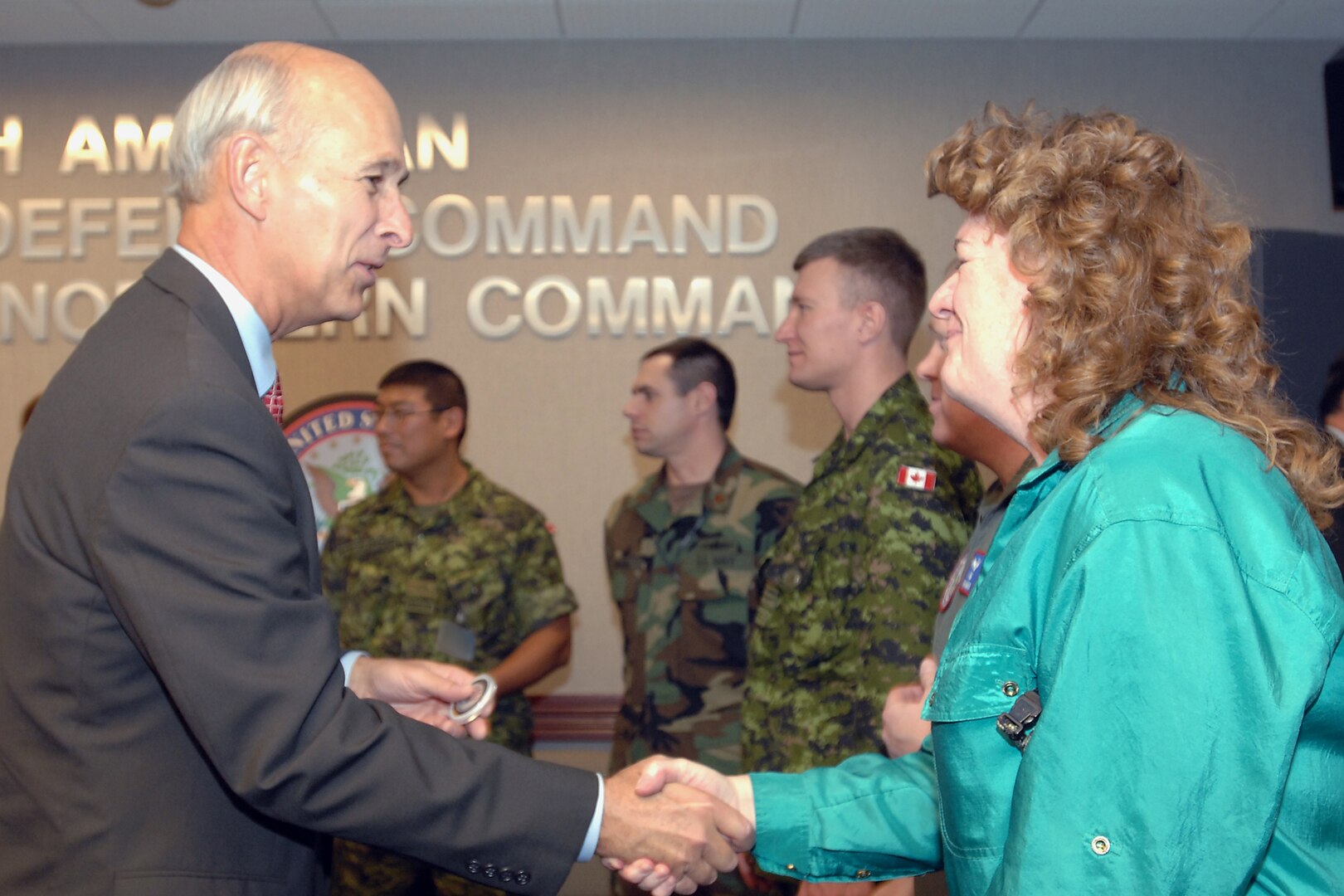The Honorable G. Kim Wincup, chairman of the Reserve Forces Policy Board, recognizes Kim Robinson of U.S. Northern Command with his coin during the Board's visit to North American Aerospace Defense Command and USNORTHCOM headquarters at Peterson Air Force Base, Colo., on April 16, 2008. Members of the Reserve Forces Policy Board, the principal policy advisor on reserve matters to the secretary of defense, came to the commands to more learn about NORAD's and USNORTHCOM's homeland defense and civil support missions. Photo by Sgt. 1st Class Gail Braymen 
