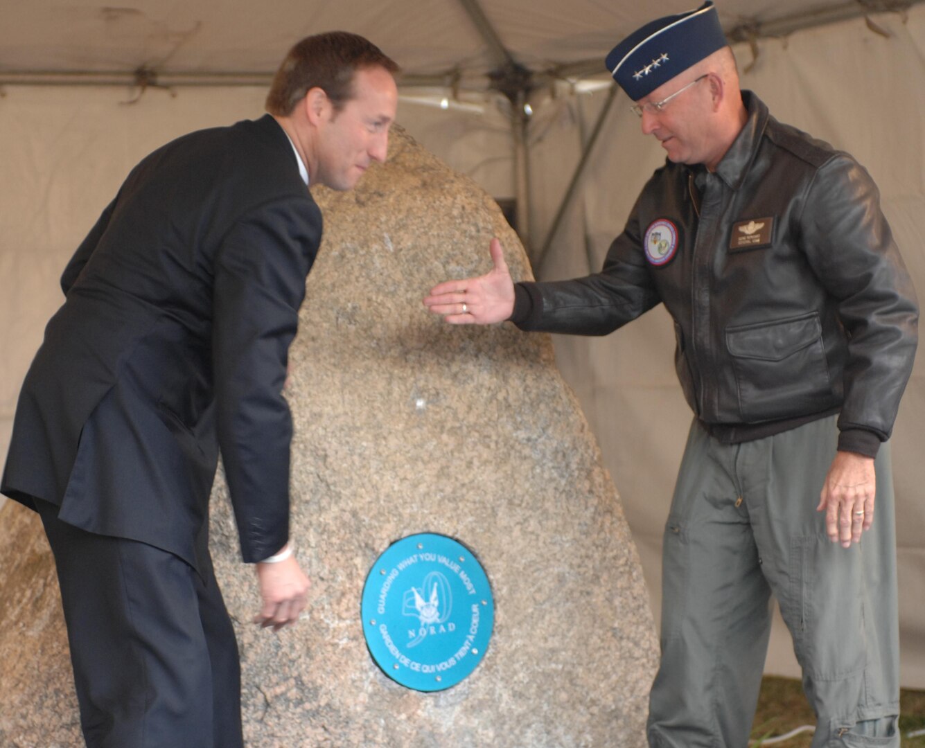 The Honorable Peter MacKay, Canada's Minister of Defence and Gen. Gene Renuart, unveil a time capsule commemorating the 50th Anniversary of NORAD. THe time capsule was placed into a rock from Cheyenne Mountain, home of the historic NORAD command post. The rock will have two commemorative plaques mounted to it, as well as the sealed time capsule, and will not be opened until NORAD's 75th anniversary in 2033. Photo by Sgt. 1st Class Gail Braymen 
