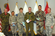 The North American Aerospace Defense Command 2008 1st quarter military award winners are, left to right: Lt.-Gen. Charlie Bouchard, deputy NORAD commander, Air Force Master Sgt. Katherine Mendez, Air Force Senior Master Sgt. Kathryn Little, Canadian Forces Capt. Mike Rogers, Air Force Maj. Stephen Georgian, NORAD and USNORTHCOM Command Senior Enlisted Leader Command Sgt. Maj. Daniel Wood. Photo by Petty Officer 1st Class Jhomil Bansil 