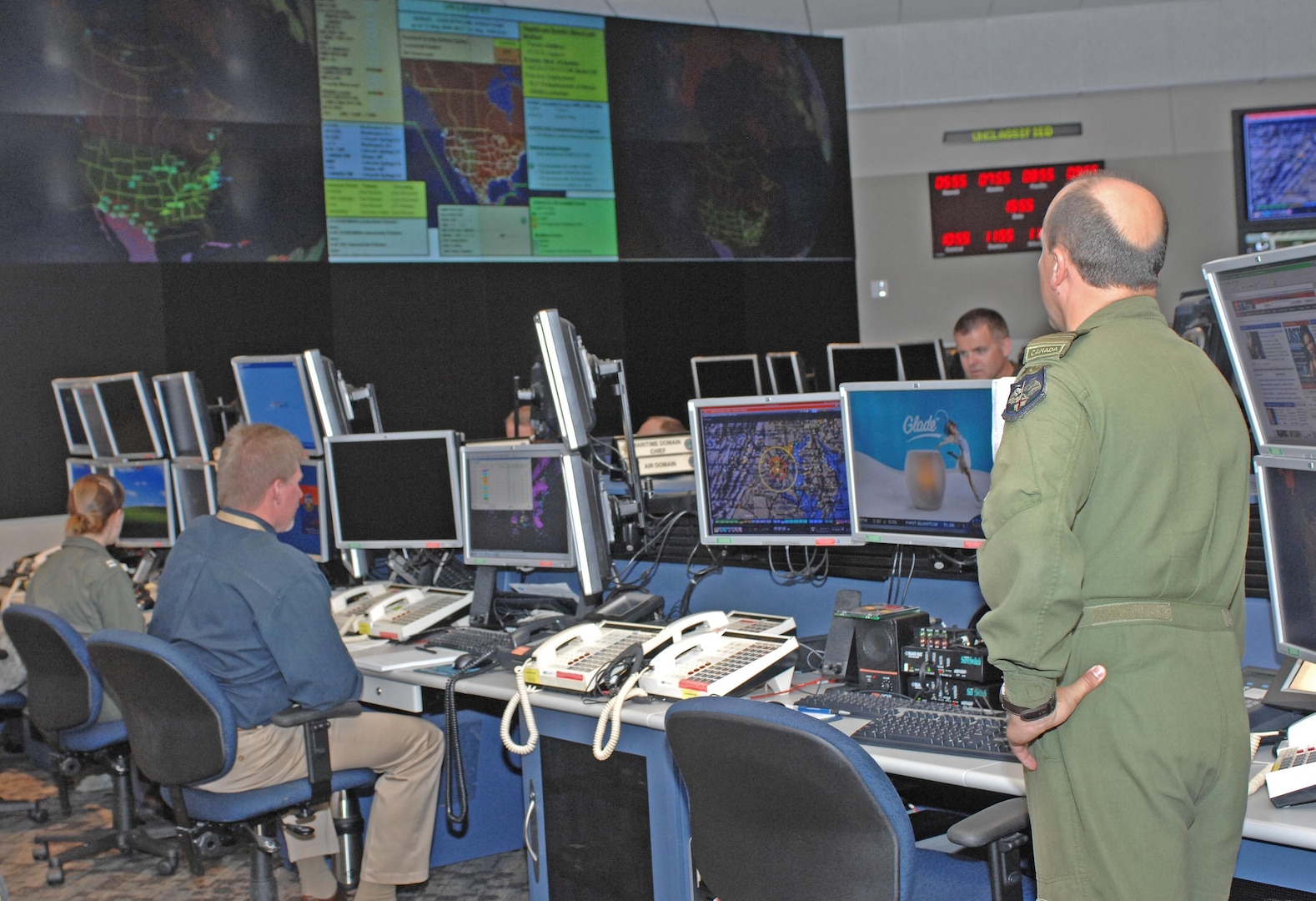 American and Canadian personnel monitor activity in the North American maritime and air domains in the new North American Aerospace Defense Command and U.S. Northern Command command center. NORAD and USNORTHCOM unveiled their new integrated command center in a May 13 ceremony at the commands’ headquarters at Peterson Air Force Base, Colo. Photo by Sgt. 1st Class Gail Braymen 