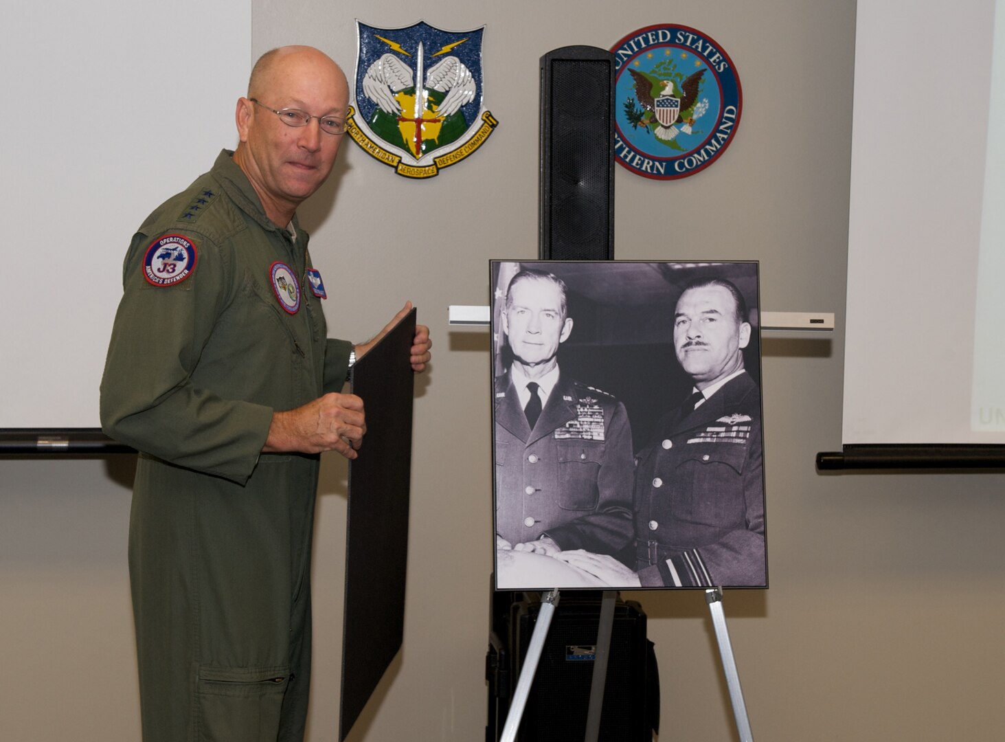 Commander of NORAD and USNORTHCOM, Gen. Gene Renuart, unveils a photo of Gen. Earl Partridge and Air Marshal Roy Sleman recently. Renuart recently approved re-naming of the Large Conference Room at NORAD and USNORTHCOM headquarters to the Partridge-Sliman Conference room in honor of the foresight and committment to international cooperation the two showed in the formative days of NORAD. Partridge was the first commander of NORAD and Sleman the first deputy. Photo by Tech. Sgt. Christopher Gish