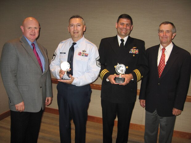 Mr. Glen Pearson, 2008 President of the Society of Manufactuirng Engineers Education Foundation (left) and Mr. Bart Aslin, Director of the foundation (far right) present Senior Master Sgt. Steven Sanchez and Cmdr. Charles Litchfield with the Outstanding Partner Award from the Society of Manufactuirng Engineers Education Foundation Oct. 6. The pair were recognized for their support of the Summer Aerospace Institute as part of NORAD and USNORTHCOM's school partnership agreement with Mitchell High School.