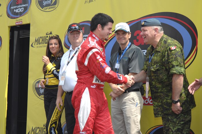 Quebec-native NASCAR driver Patrick Carpentier is warmly greeted by Lt. Gen. Charlie Bouchard, the NORAD Deputy Commander, during the opening ceremonies at the Michigan International Speedway (MIS). Lt. Gen. Bouchard was at MIS as a guest of the speedway during NORAD 50th Anniversary celebrations. Photo by Canadian Forces Lt. Desmond James 